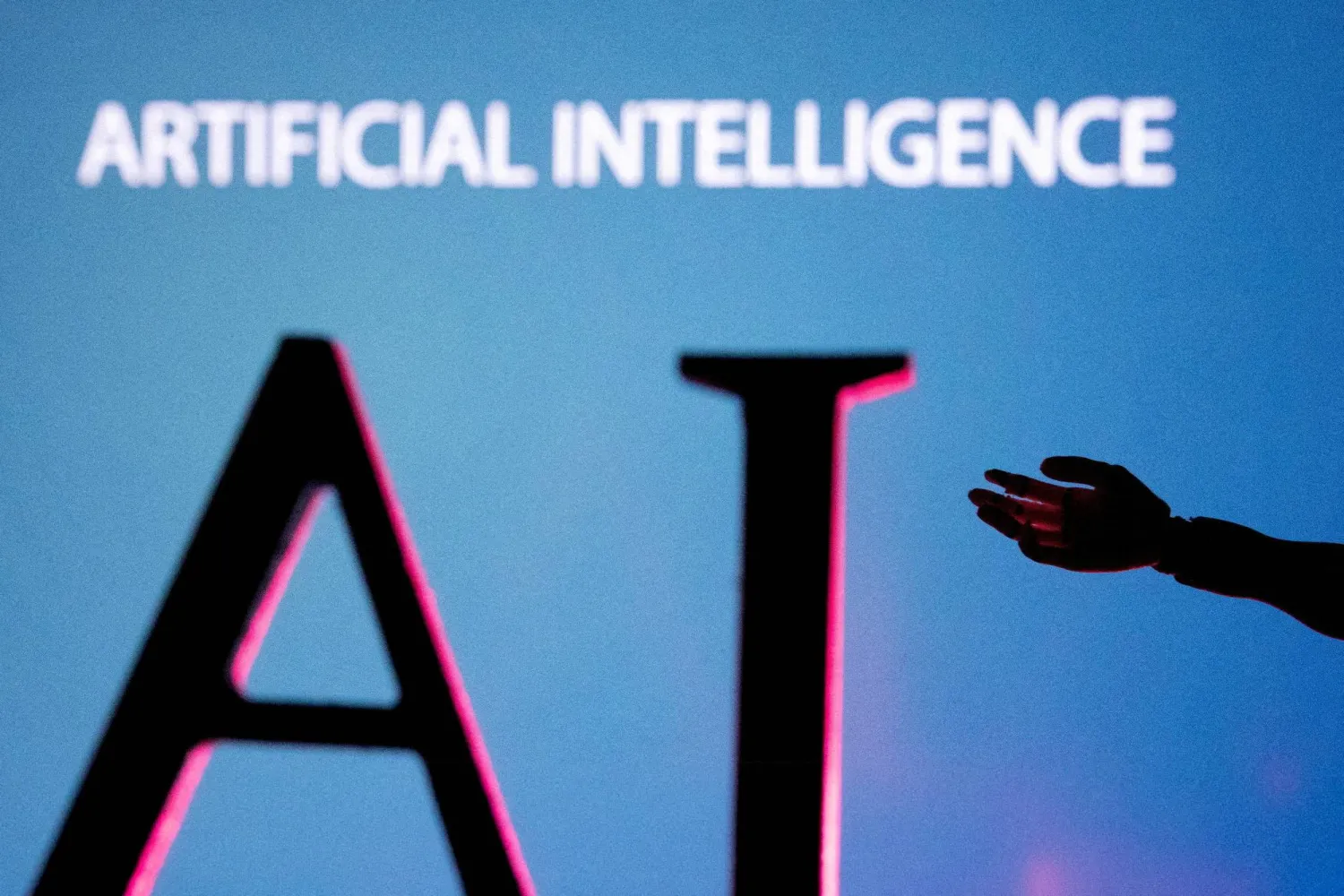 AI (Artificial Intelligence) letters and robot hand miniature in this illustration taken, June 23, 2023. (Reuters)