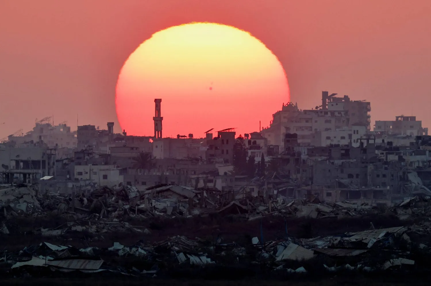 The sun sets over Gaza, as seen from the Israeli side of the border, August 2, 2026. (Reuters)