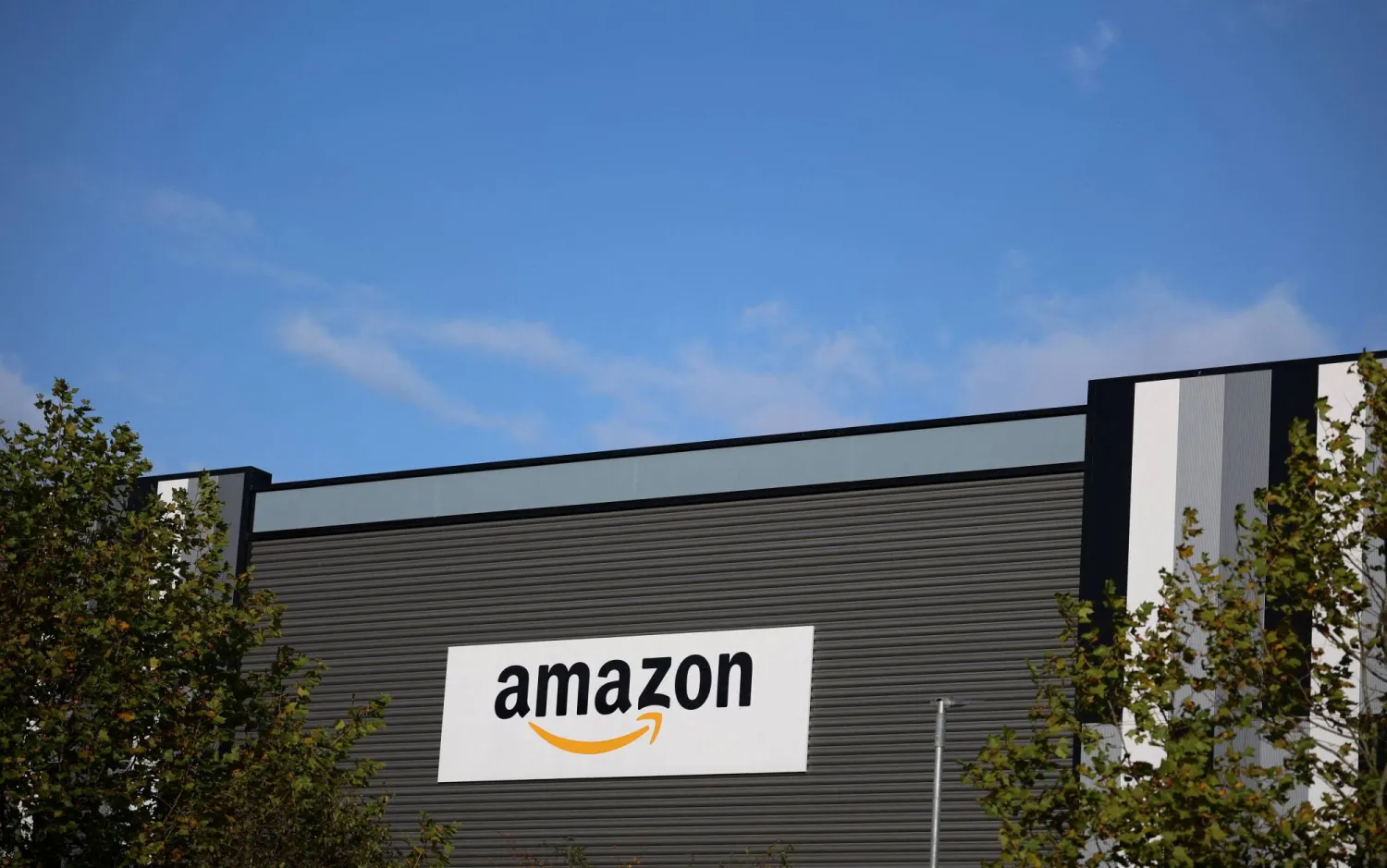 The Amazon logo outside an Amazon warehouse in Manchester, Britain, October 28, 2025. (Reuters)
