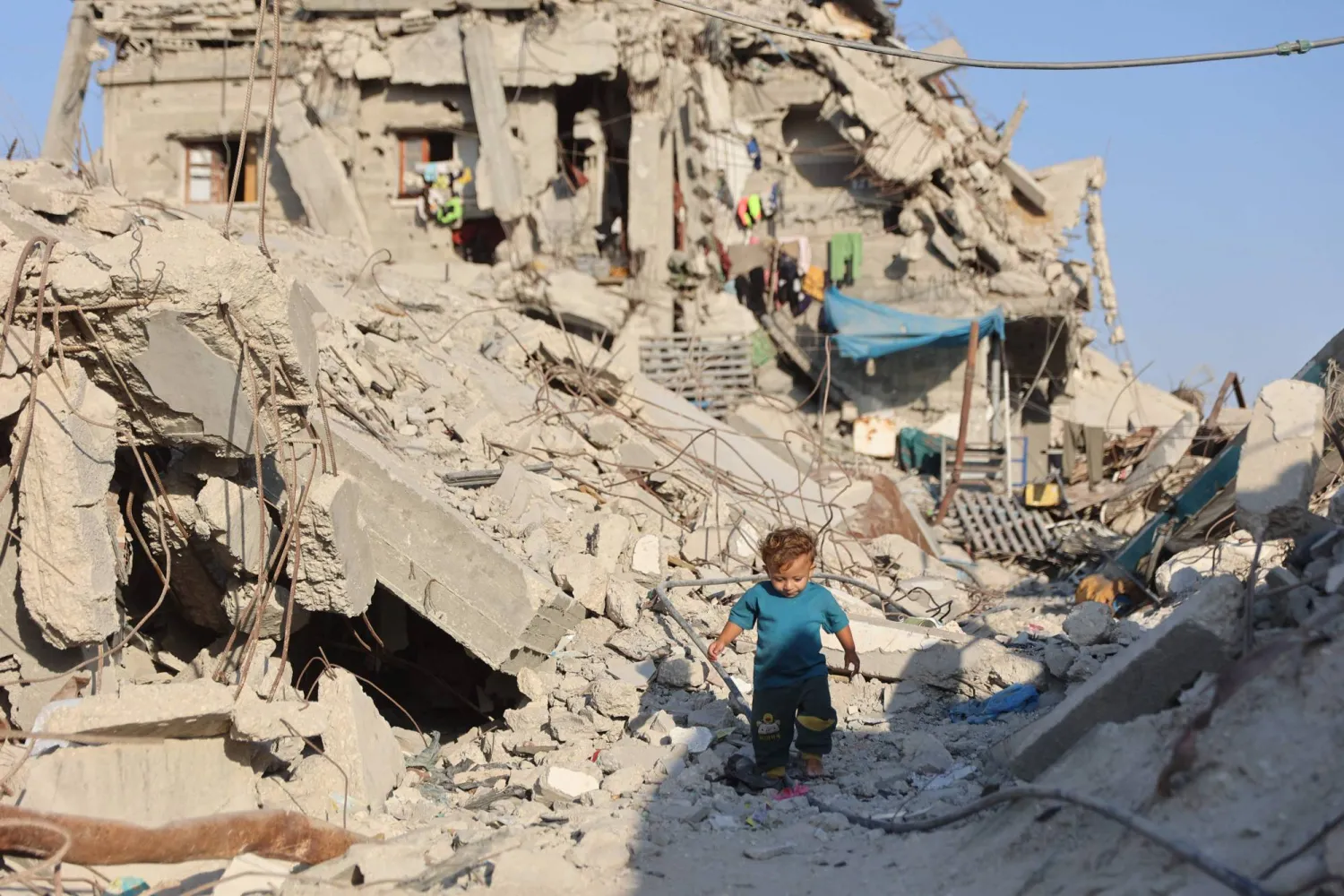 A Palestinian child walks past the rubble of destroyed buildings in the Jabalia camp for Palestinian refugees in the northern Gaza Strip on August 2, 2026. (AFP)