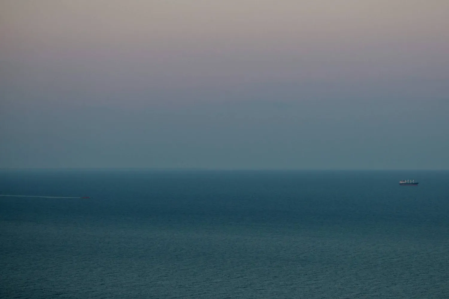 This photograph taken on July 26, 2026, shows the sinking of the Golden Leo (L) off the Odesa coast after a Russian attack on the cargo ship leaving Ukraine's port of Odesa that killed 10 people on July 19, 2026, amid the Russian invasion of Ukraine. (AFP)