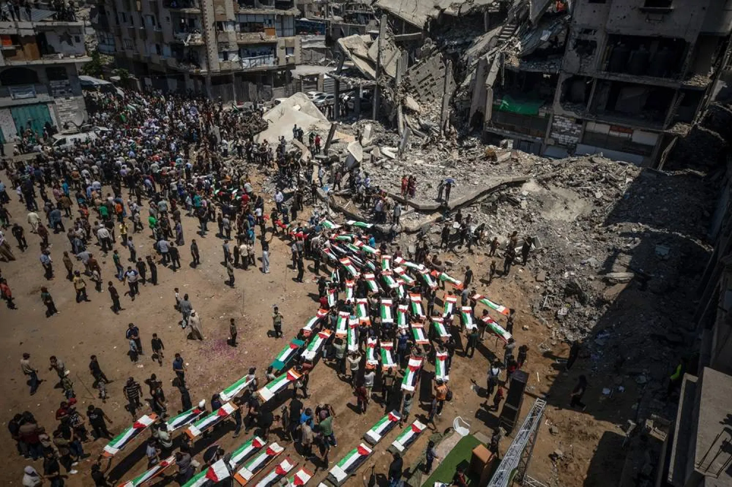Palestinians gather during a mass funeral for 112 members of the Abu Sharia and Al-Hasayna families in the eastern Gaza City, 04 August 2026. (EPA)