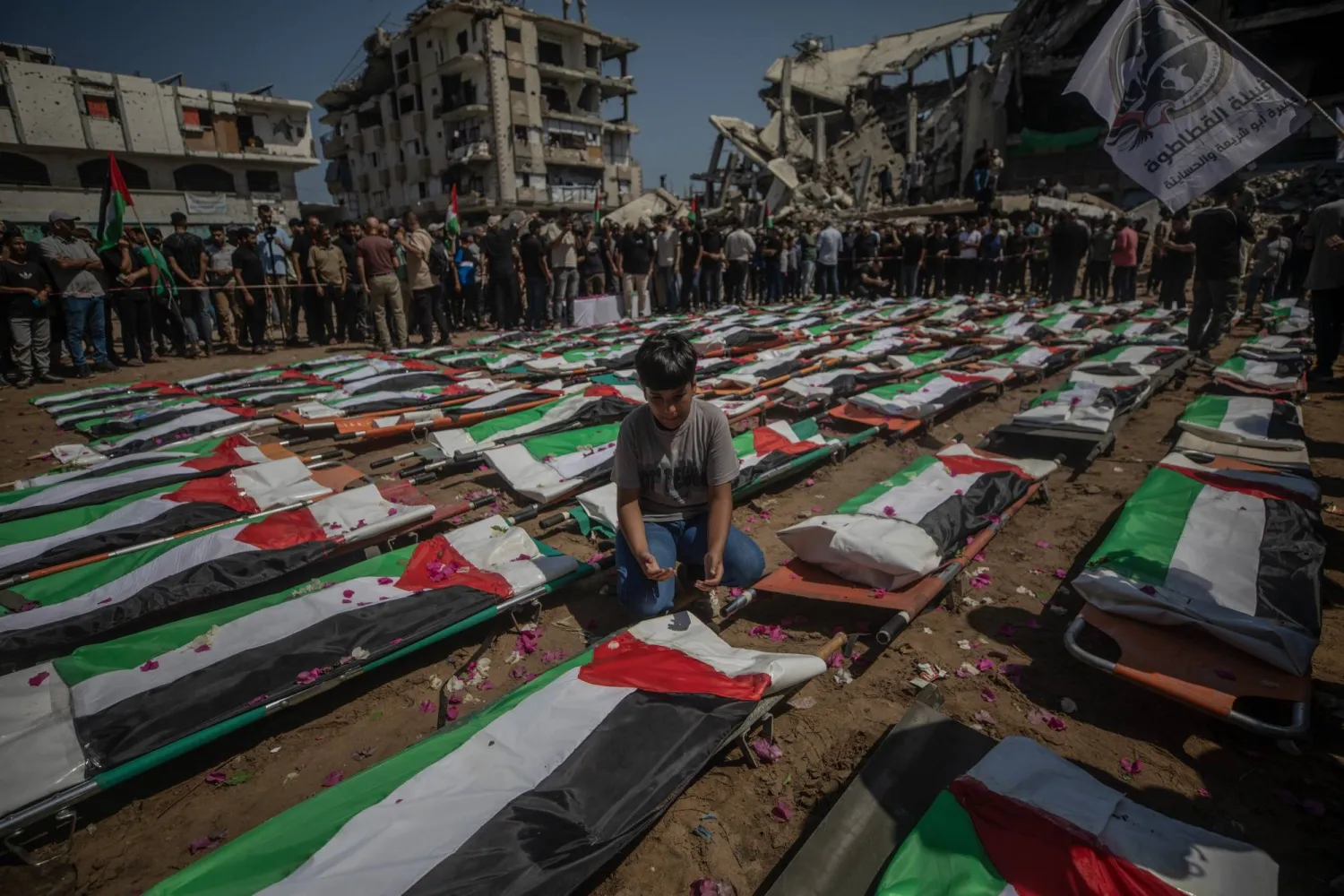 Palestinians gather during a mass funeral for 112 members of the Abu Sharia and Al-Hasayna families in the eastern Gaza City, 04 August 2026. (EPA)