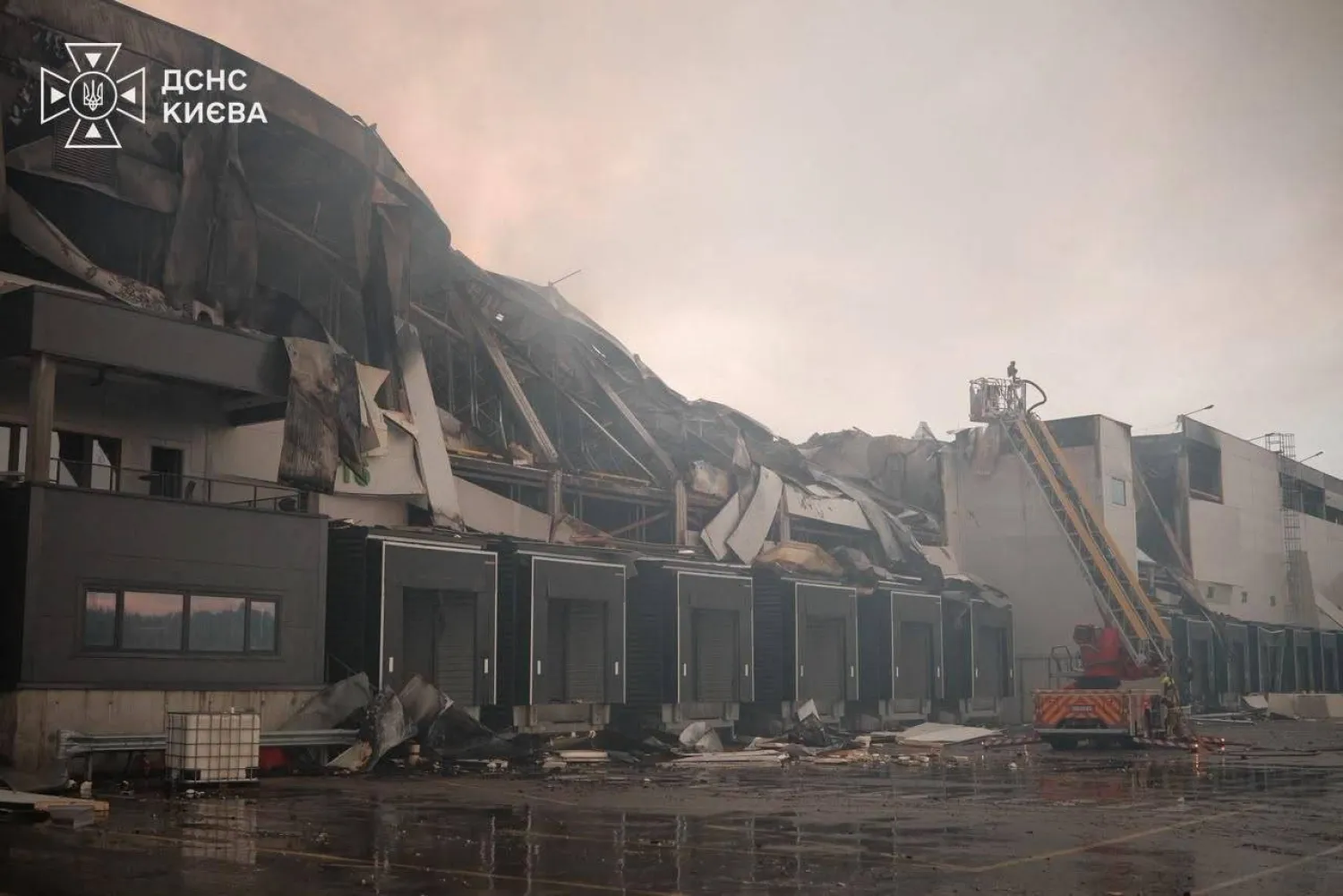 This handout photograph taken and released by Ukrainian State Emergency Service on August 5, 2026 shows rescuers working outside a warehouse premises damaged following massive Russian ballistic missile and drones strikes in the Ukrainian capital of Kyiv. (Photo by Handout / Ukrainian State Emergency Service / AFP)