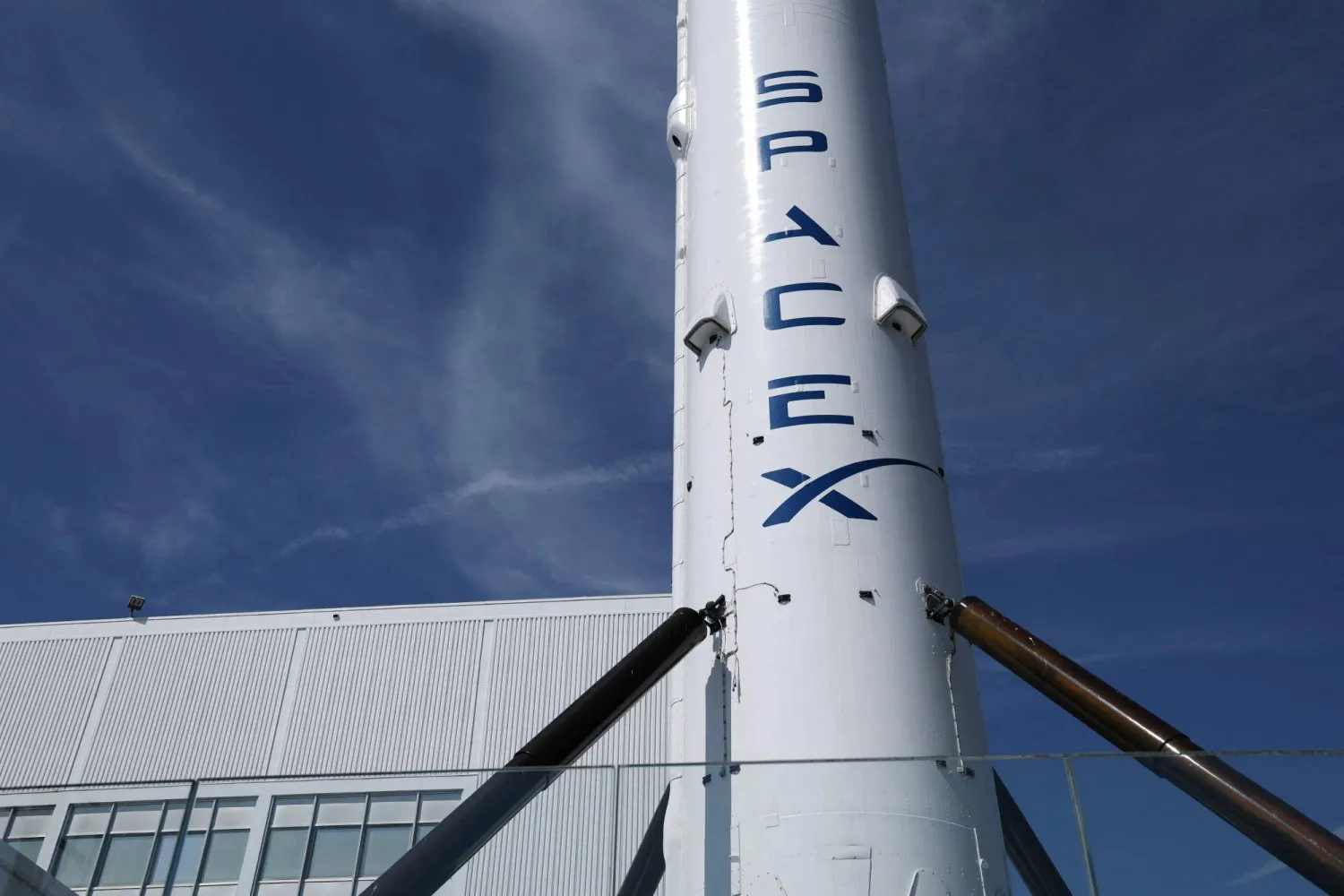 (FILES) A SpaceX Falcon 9 rocket is displayed outside a Space Exploration Technologies Corp. facility in Hawthorne, California on March 26, 2026. (Photo by Patrick T. Fallon / AFP)