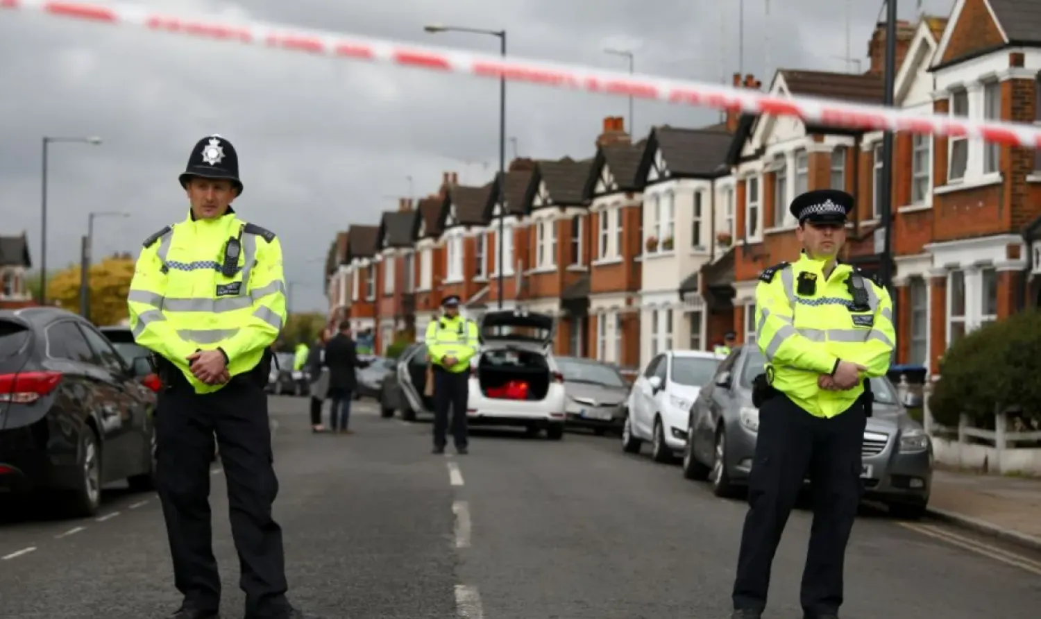 Police officers stand next to terraced housing in Harlesden Road, north London. Photo: Reuters