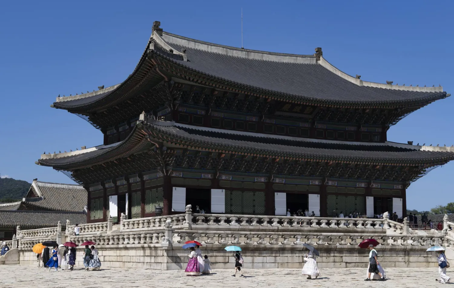 Tourists wearing traditional Korean clothing visit Gyeongbokgung Palace while holding umbrellas to seek relief from the extreme heat in Seoul, South Korea, 06 August 2026. EPA/JEON HEON-KYUN
