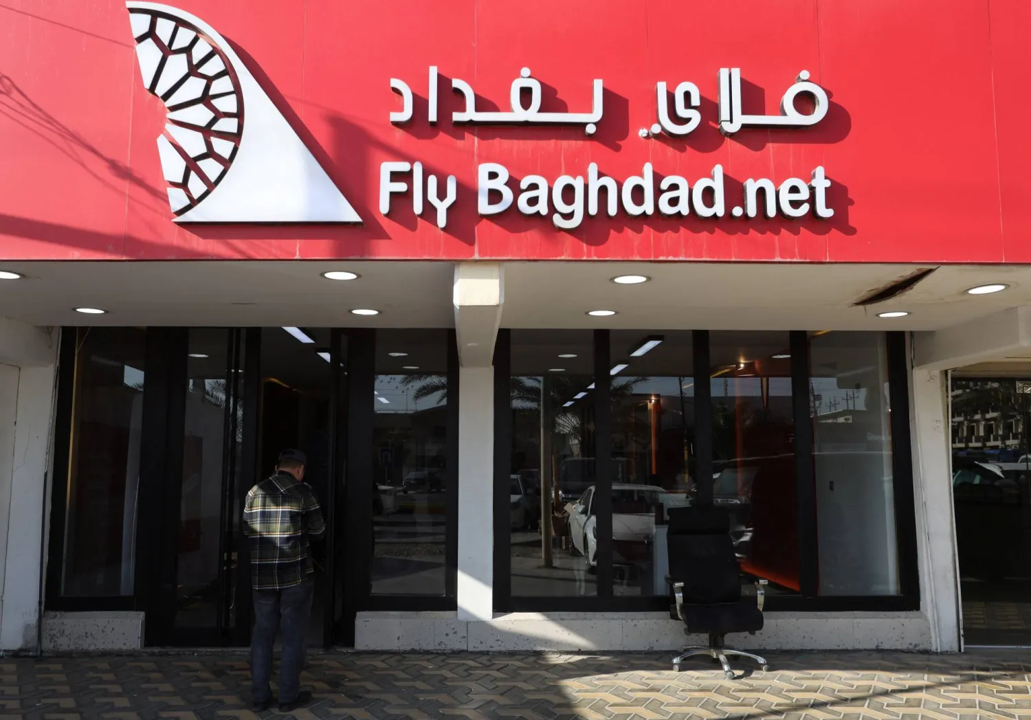 A man stands outside the office of Fly Baghdad airline, in Baghdad, Iraq January 23, 2024. REUTERS/Ahmed Saad