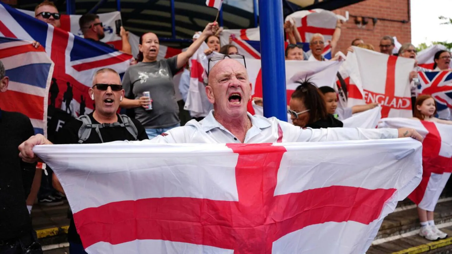 File photo: People demonstrating under the Abolish Asylum System slogan outside the Castle Bromwich Holiday Inn in Birmingham, England, on August 24, 2025. Jacob King, AP
