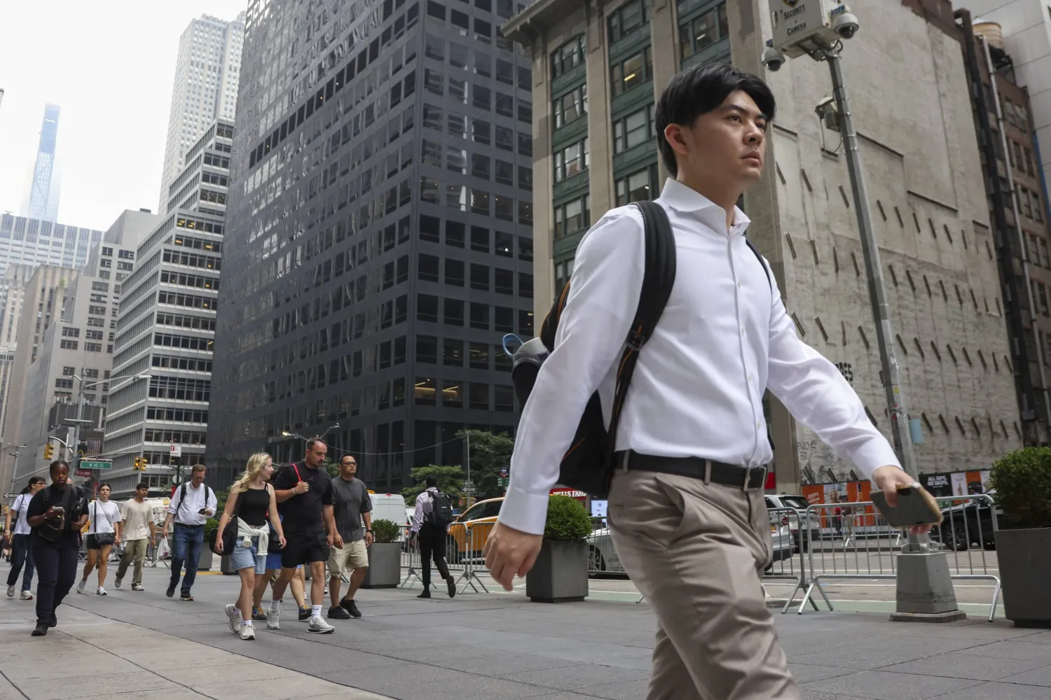 People walk on the sidewalk in midtown Manhattan in New York, New York, US, 06 August 2026. (EPA)
