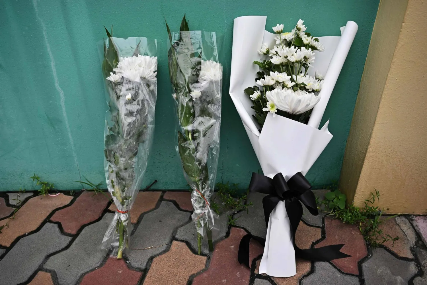 Flowers are left outside Debsirin Nonthaburi secondary school the day after the shooting in Nonthaburi province, north of Thailand's capital Bangkok, on August 8, 2026. (AFP)