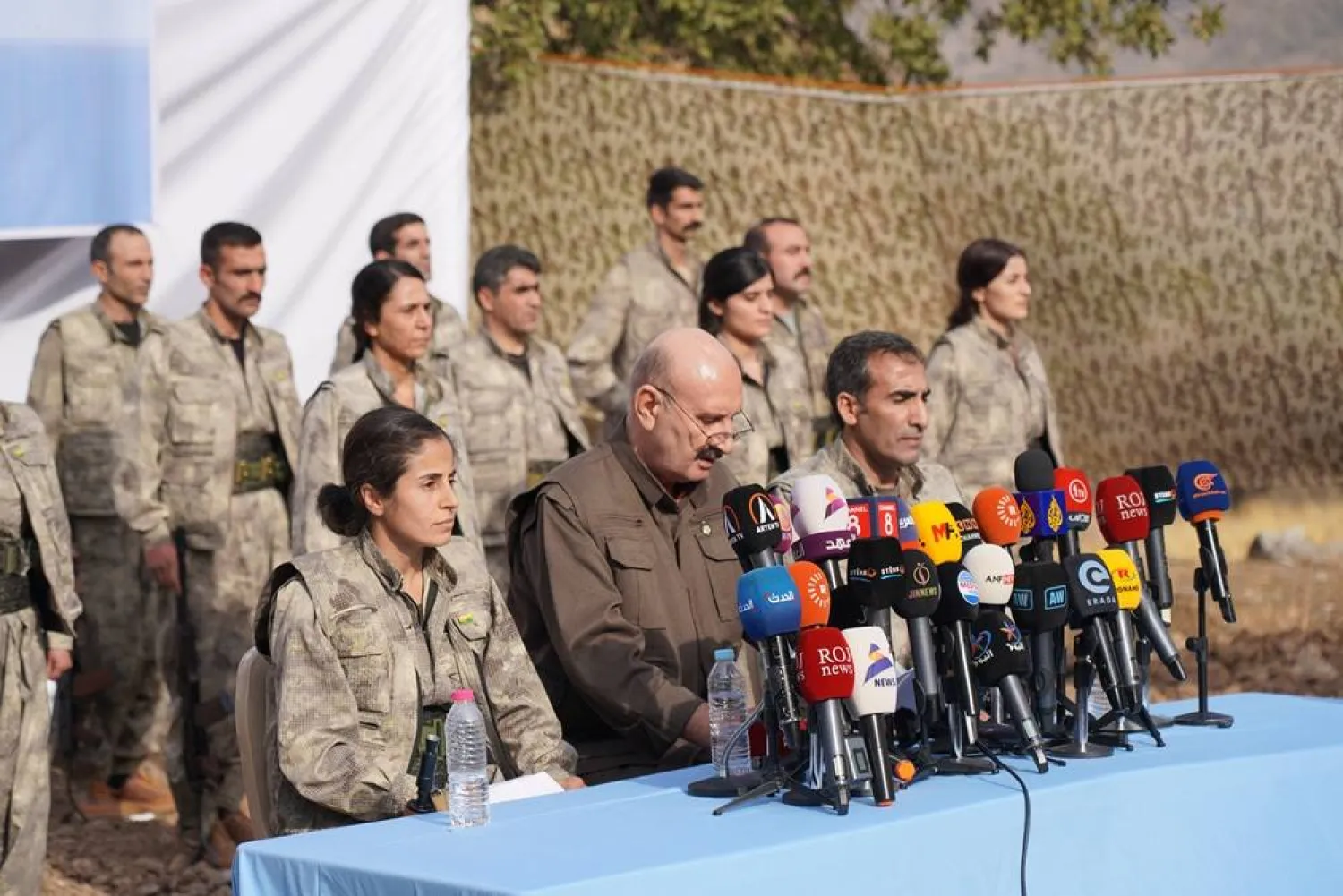 Kurdistan Workers' Party (PKK) fighters, who reportedly withdrew from Türkiye with their weapons, stand to attention during a ceremony in the Qandil area of northern, Iraq, Sunday, Oct 26, 2025. (AP) 
