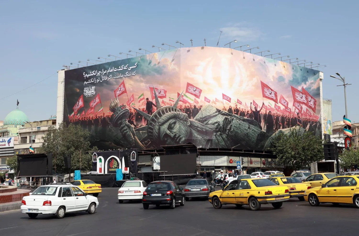 Vehicles drive past an anti-US billboard at Enghelab Square in central Tehran, Iran, 09 August 2026. EPA/ABEDIN TAHERKENAREH 