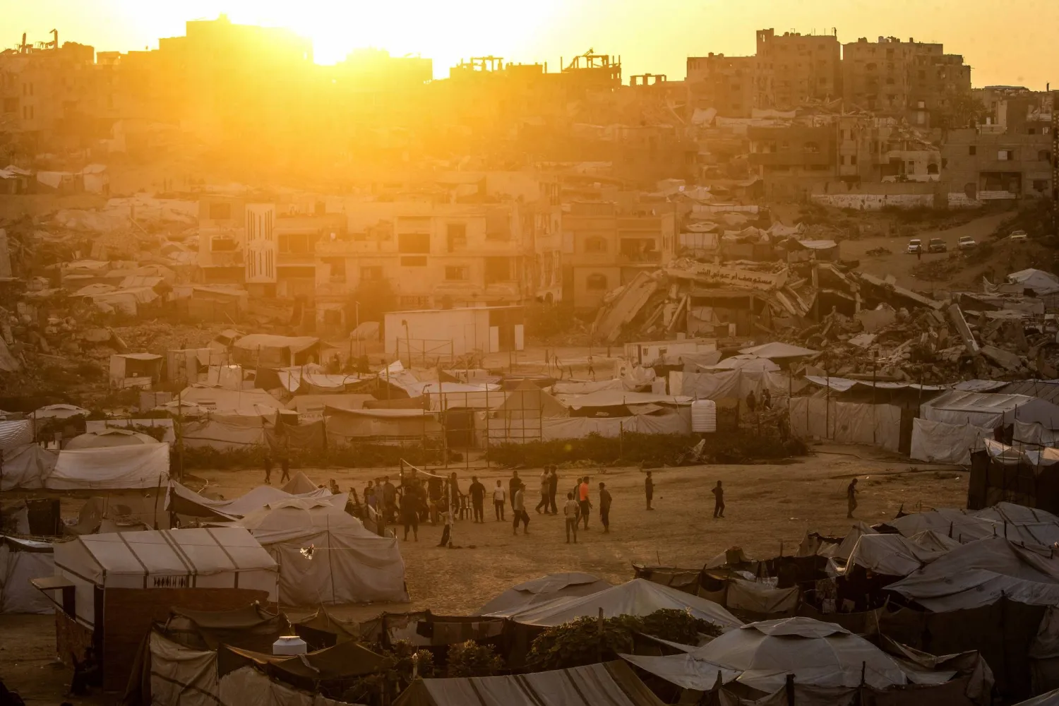 Displaced Palestinian youths play volleyball between destroyed houses in Jabaliya, northern Gaza City, 07 August 2026. (EPA)