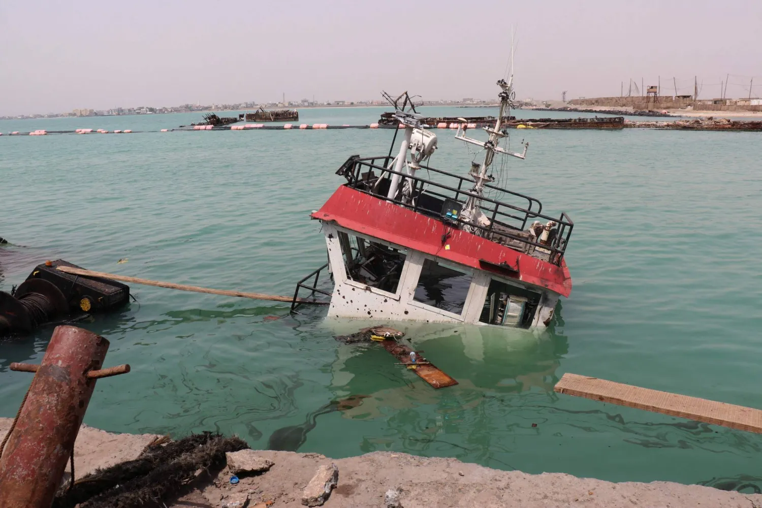 The navigation bridge of a sunken vessel is all that is seen at the surface of the water in the Port of Mokha the day after an attack by the Houthis on the city Mokha, held by Yemen's legitimate government on August 10, 2026. (AFP)