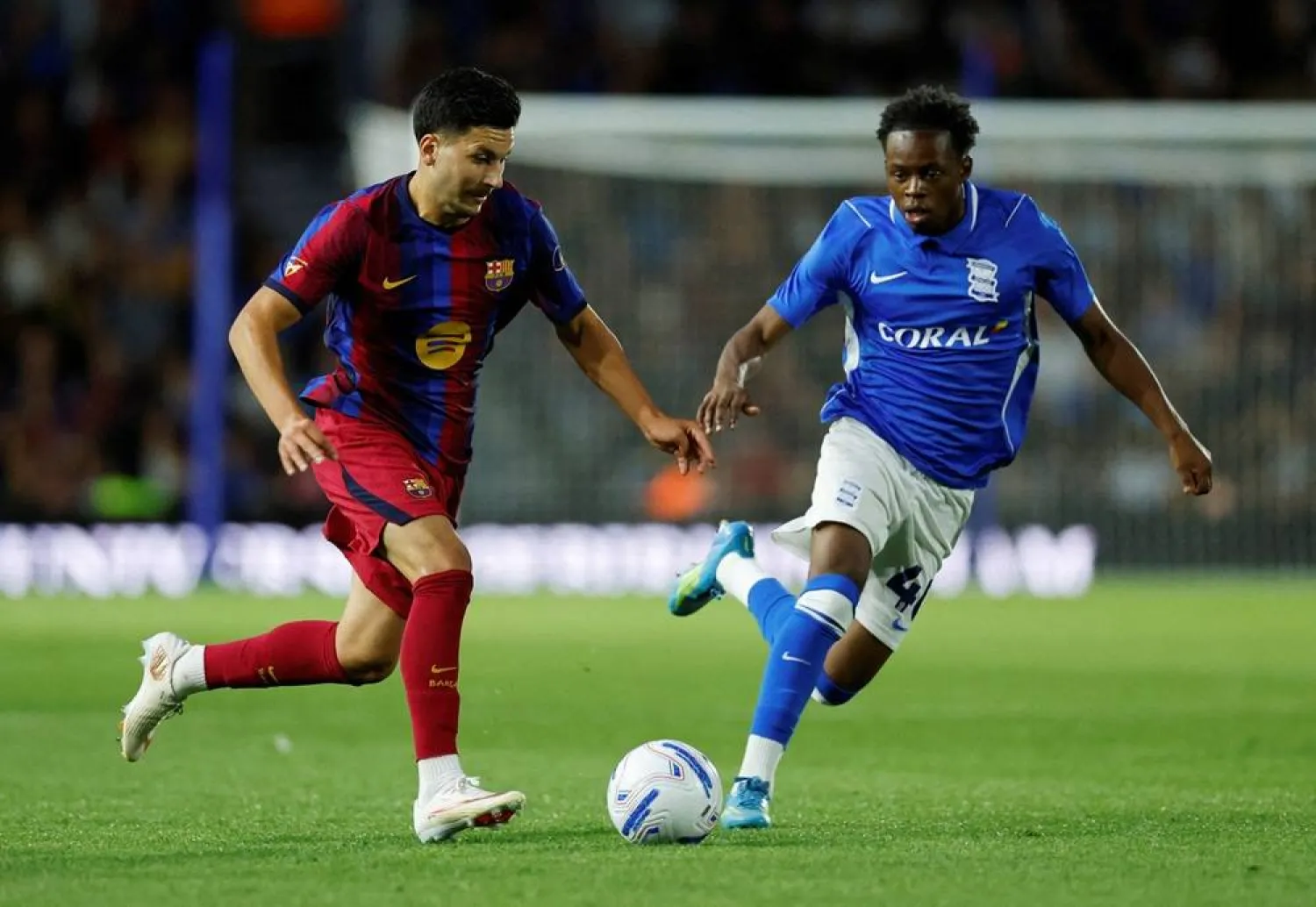 Football - Pre-Season Friendly - Birmingham City v FC Barcelona - St Andrew's - Knighthead Park, Birmingham, Britain - July 31, 2026 FC Barcelona's Roony Bardghji in action with Birmingham City's Menzi Mazw. (Reuters)