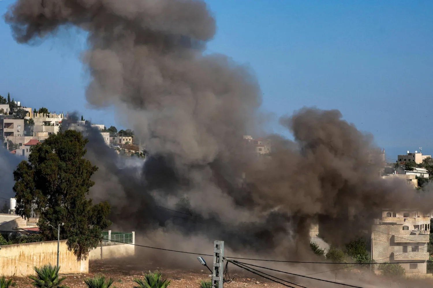 Smoke rises during an Israeli controlled-demolition from the home of Palestinian Farouk Ramadan, who was involved and killed in clashes with Israeli settlers on July 24, killing two, in the Palestinian village of Tell in the occupied West Bank on August 11, 2026. (AFP)