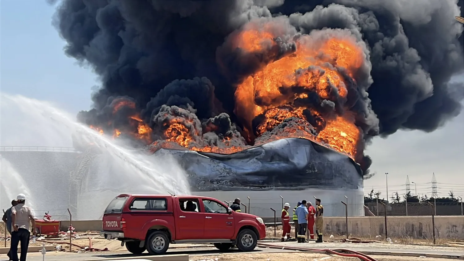 Firefighters work to extinguish a fire at a fuel storage tank at the Zawiya oil depot, west of Tripoli, Libya, 11 August 2026. (EPA)