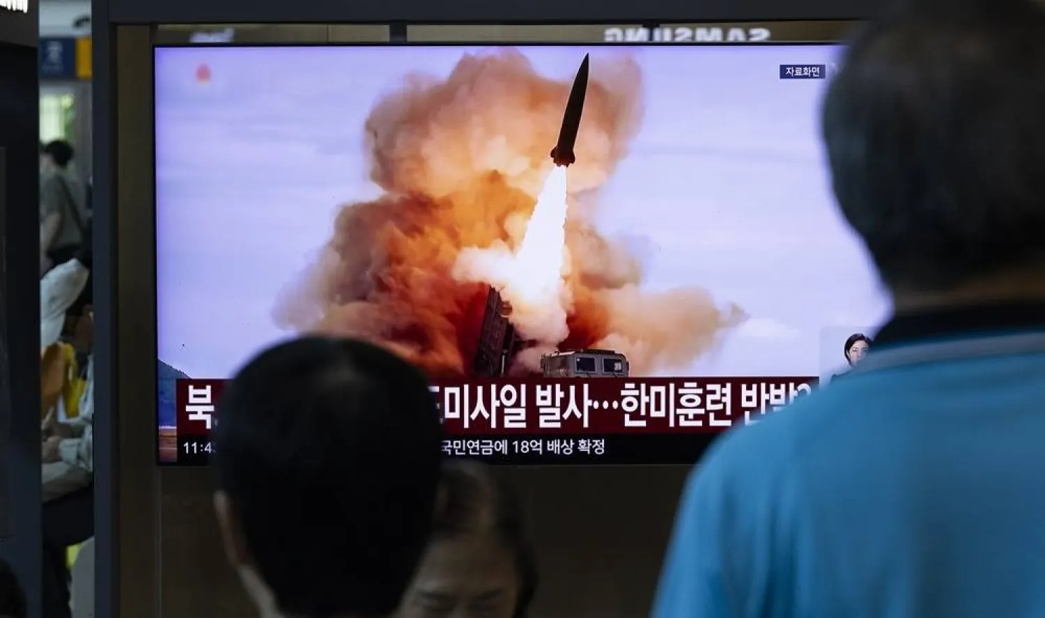 People watch a news broadcast on a television screen showing a report on a missile launch, at a railway station in Seoul, South Korea, 12 August 2026. (EPA)