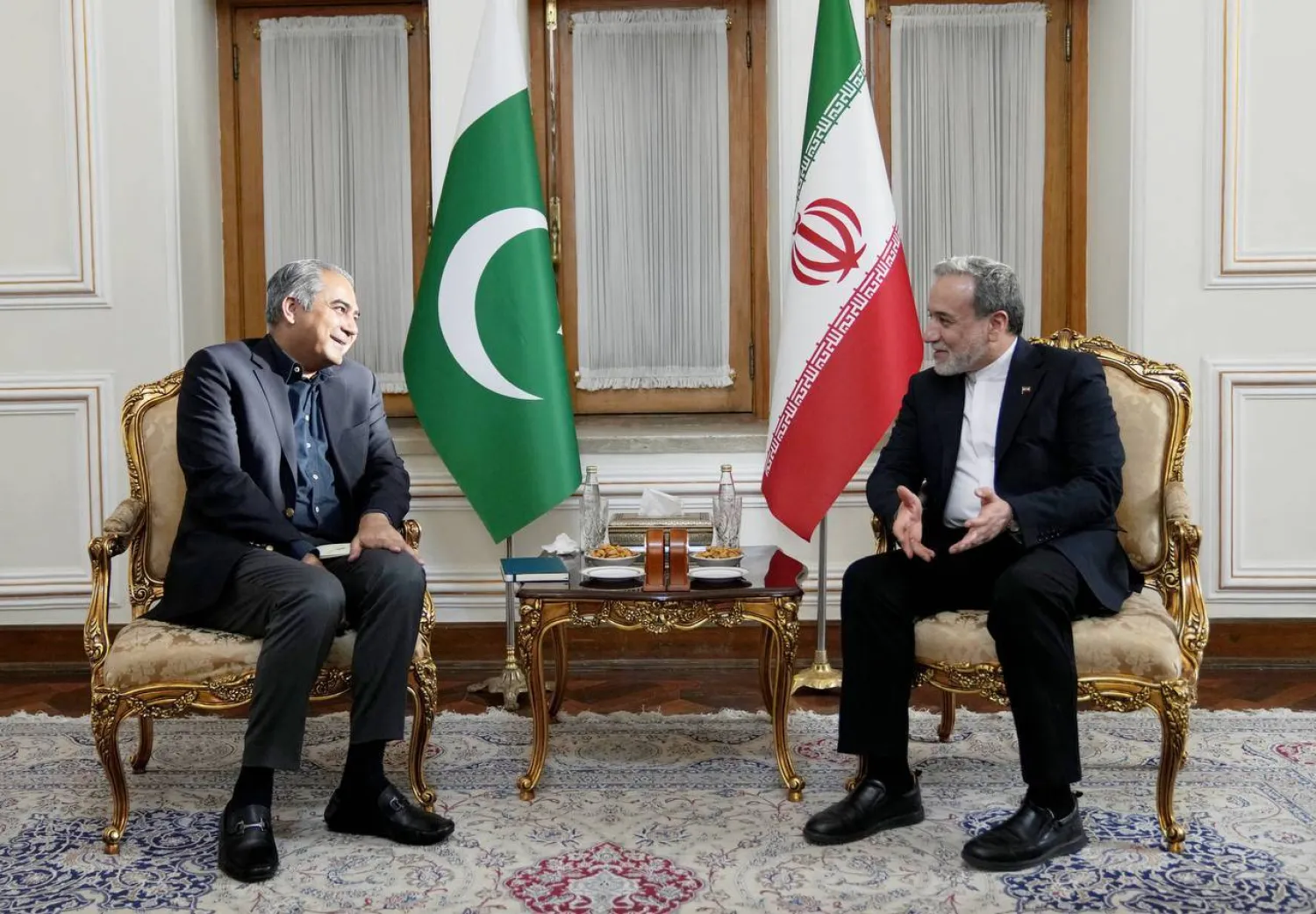 A handout photo made available by the Iranian Foreign Ministry Office shows Iranian Foreign Minister Abbas Araghchi (R) meeting with Pakistan's Minister of Interior Mohsin Naqvi in Tehran on August 11, 2026. (Iran Foreign Ministry / AFP) 