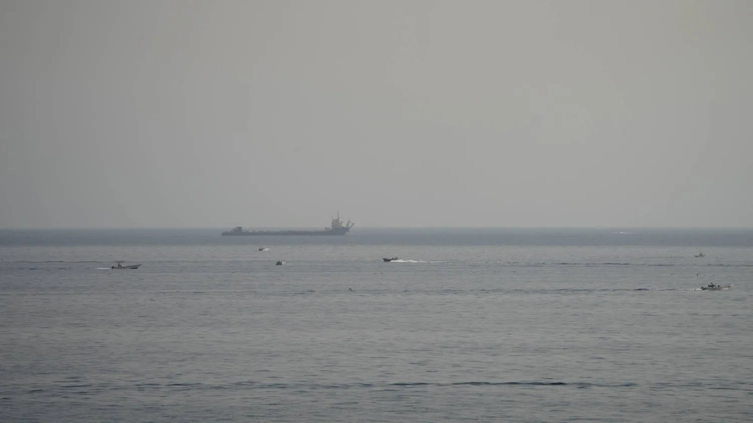 Boats and a vessel in the Strait of Hormuz, as seen from Musandam, Oman, August 3, 2026. (Reuters)