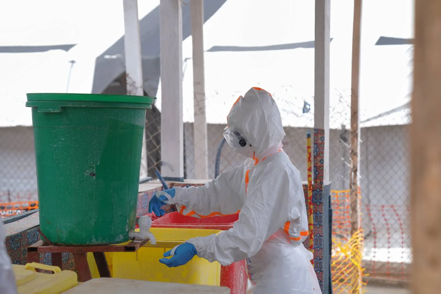 A health worker in protective gear washes her hands at the treatment center in Bunia General Hospital in Ituri, eastern Congo, Tuesday, Aug. 11, 2026. (AP)