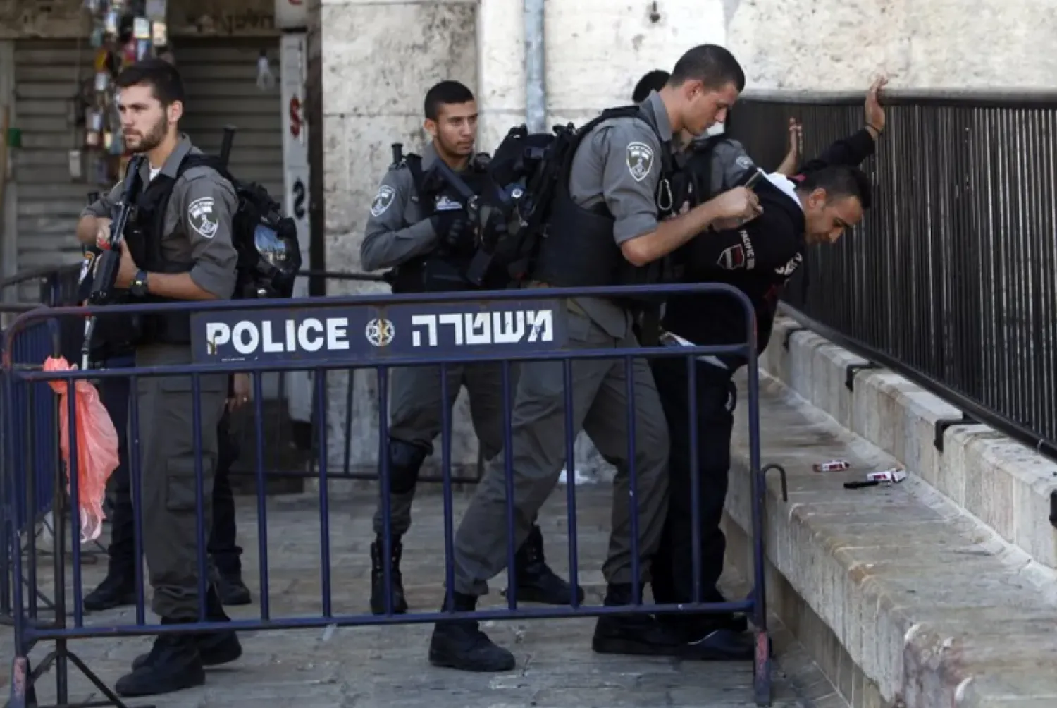 Israeli border police officers search a Palestinian man near the scene of a stabbing attack in Jerusalem's old city, Monday, Sept. 19, 2016. (AP Photo/Mahmoud Illean)
