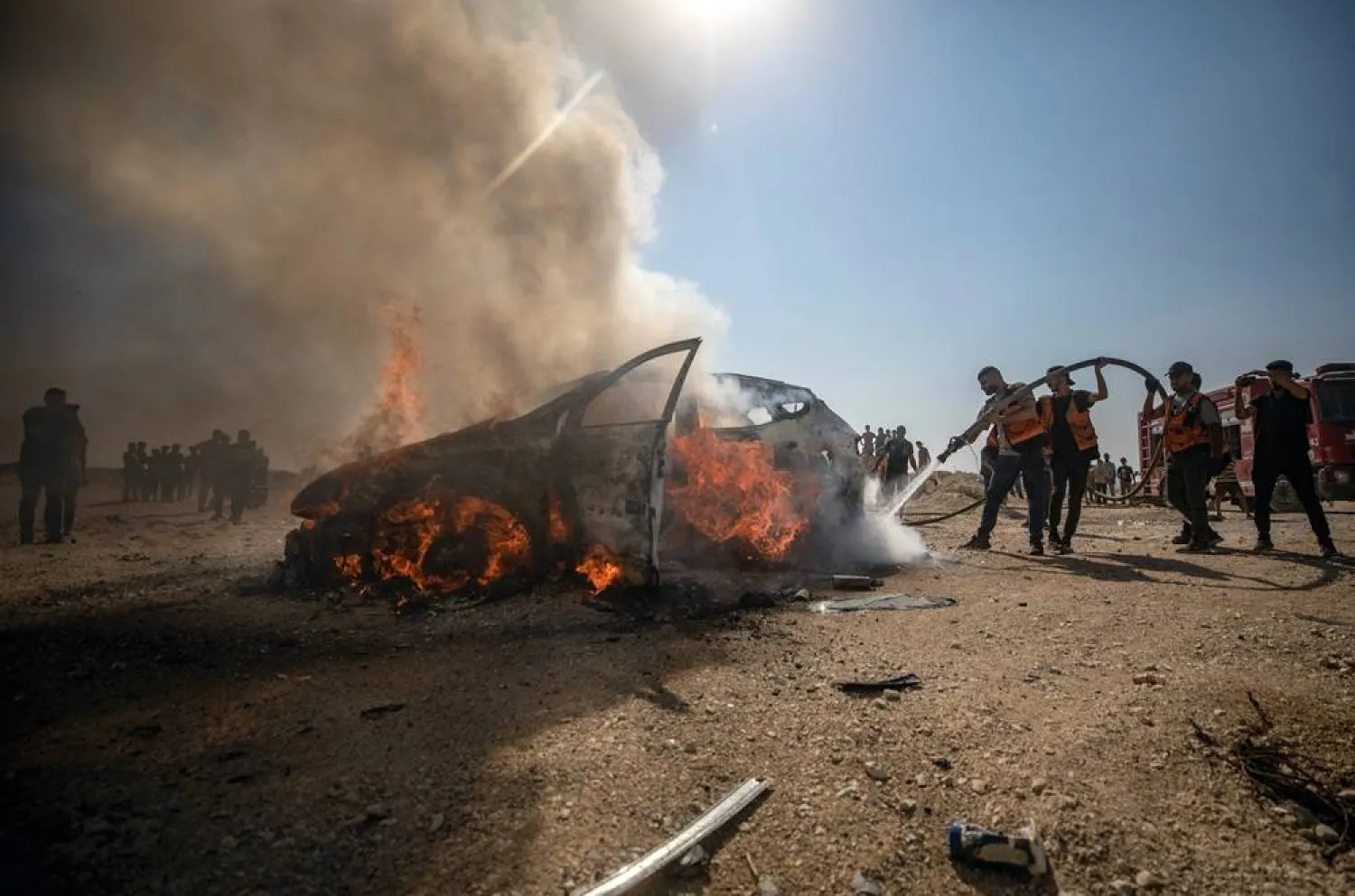 Palestinian firefighters attempt to extinguish a fire after an Israeli military strike targeted a vehicle belonging to Gaza Police Chief Jamal Abu Kamil south of Gaza City, 13 August 2026. (EPA) 