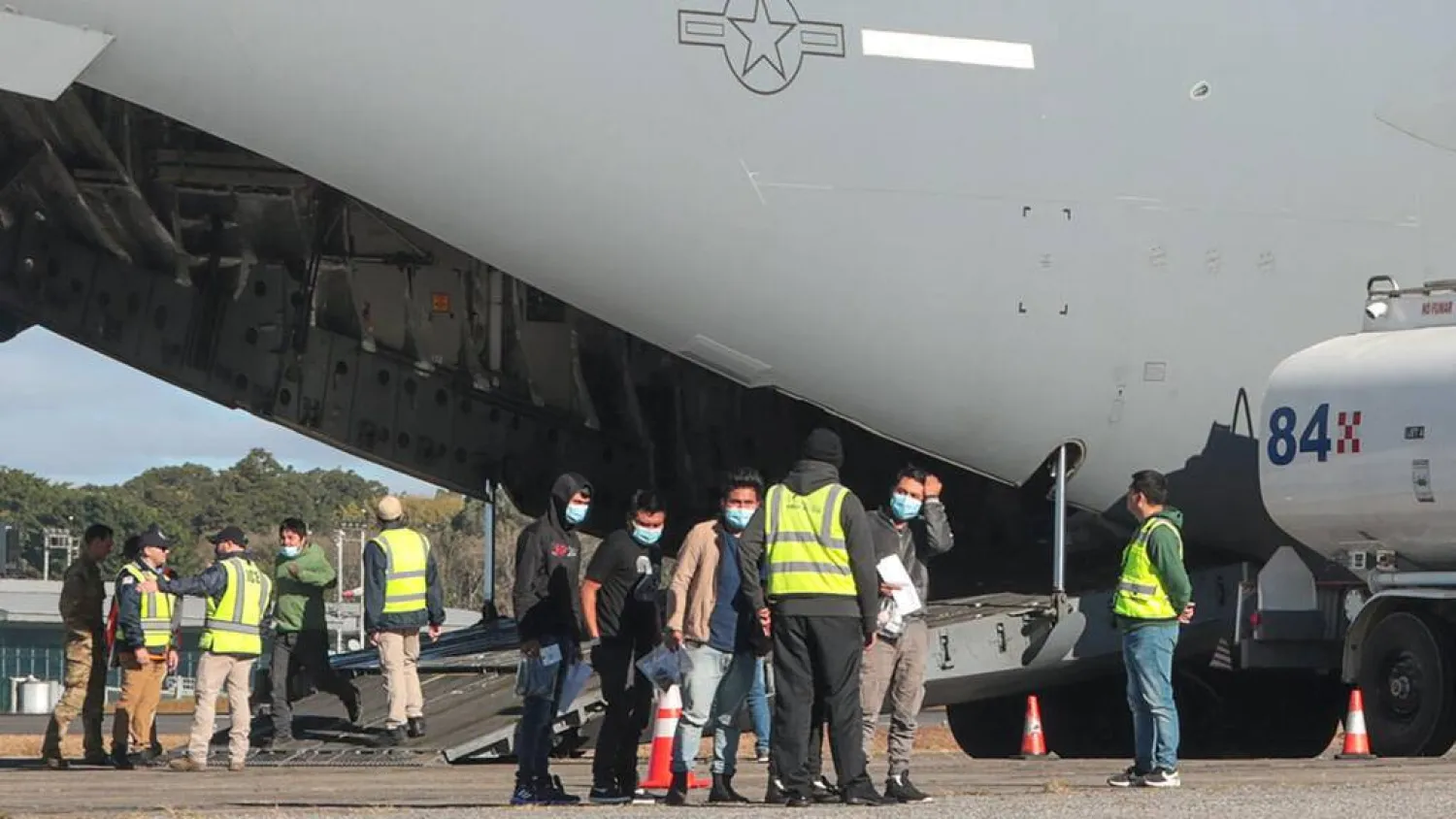 Handout picture released by Guatemalan Migration Institute shows Guatemalan migrants descending from an US military plane after being deported from US at the Guatemalan Air Force Base in Guatemala City on January 24, 2025. Guatemalan Migration Institute via AFP
