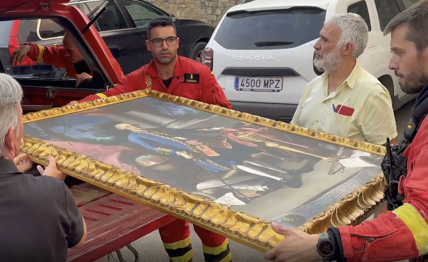 This screen grab of a handout video taken and released by Spain's Military Emergencies Unit (UME) shows firefighters taking away a painting amid a wildfire threatening San Juan de la Pena Monastery in Penas de Riglos in the Spanish southwestern province of Aragon, on August 13, 2026. (Photo by Handout / UME / AFP) 