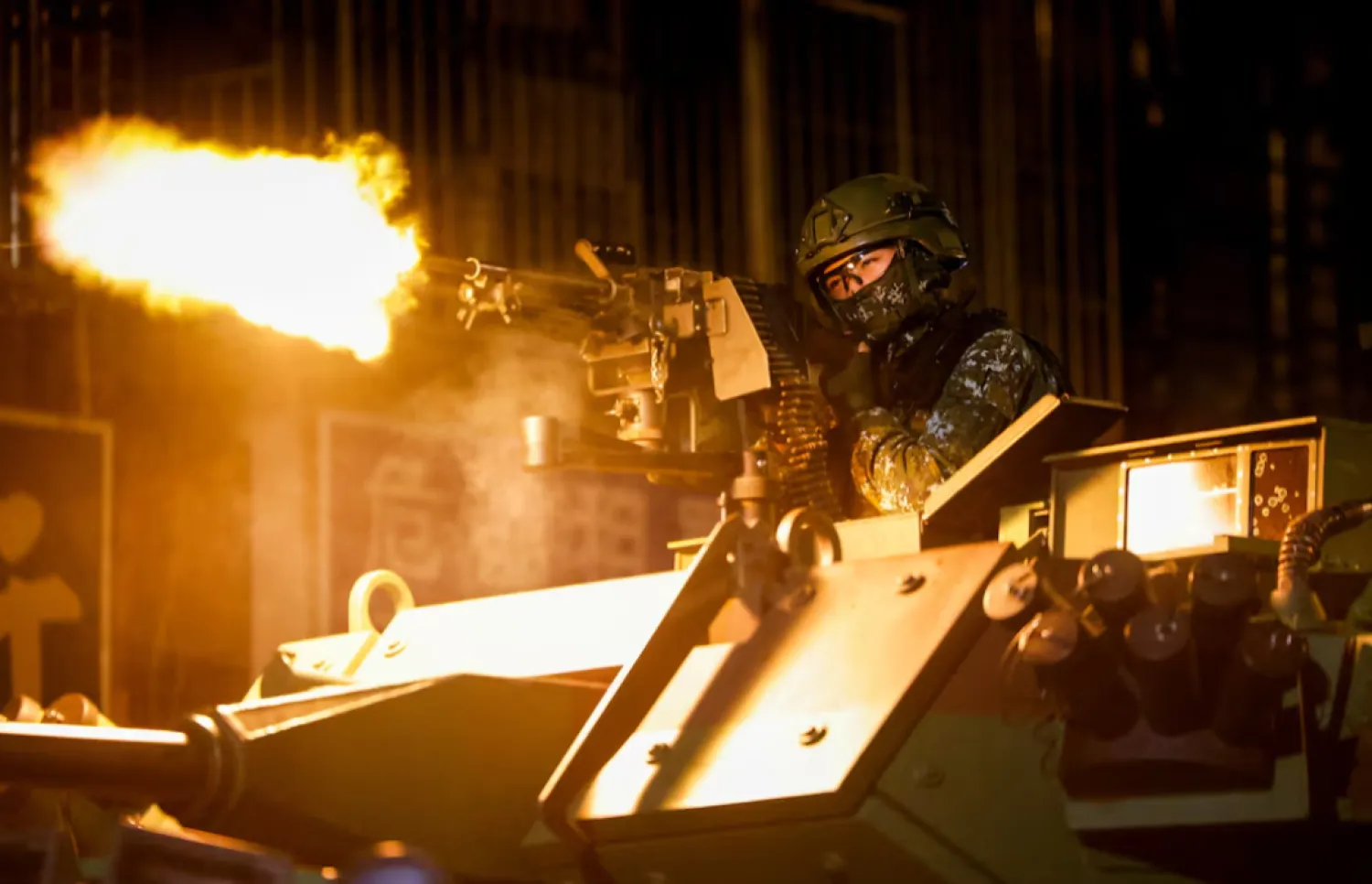 A Taiwanese military member fires ammunition aboard an armoured vehicle during a drill as part of the annual Han Kuang military exercises in Taipei, Taiwan, August 13, 2026. REUTERS/Ann Wang 