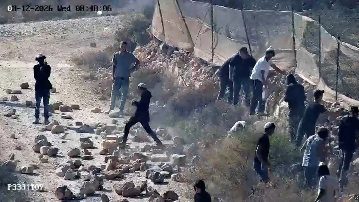 CCTV footage shows, as witnesses say, Jewish settlers throwing rocks on the road in Qusra, in the Israeli-occupied West Bank, August 12, 2026 in this screengrab taken from a handout video- REUTERS 