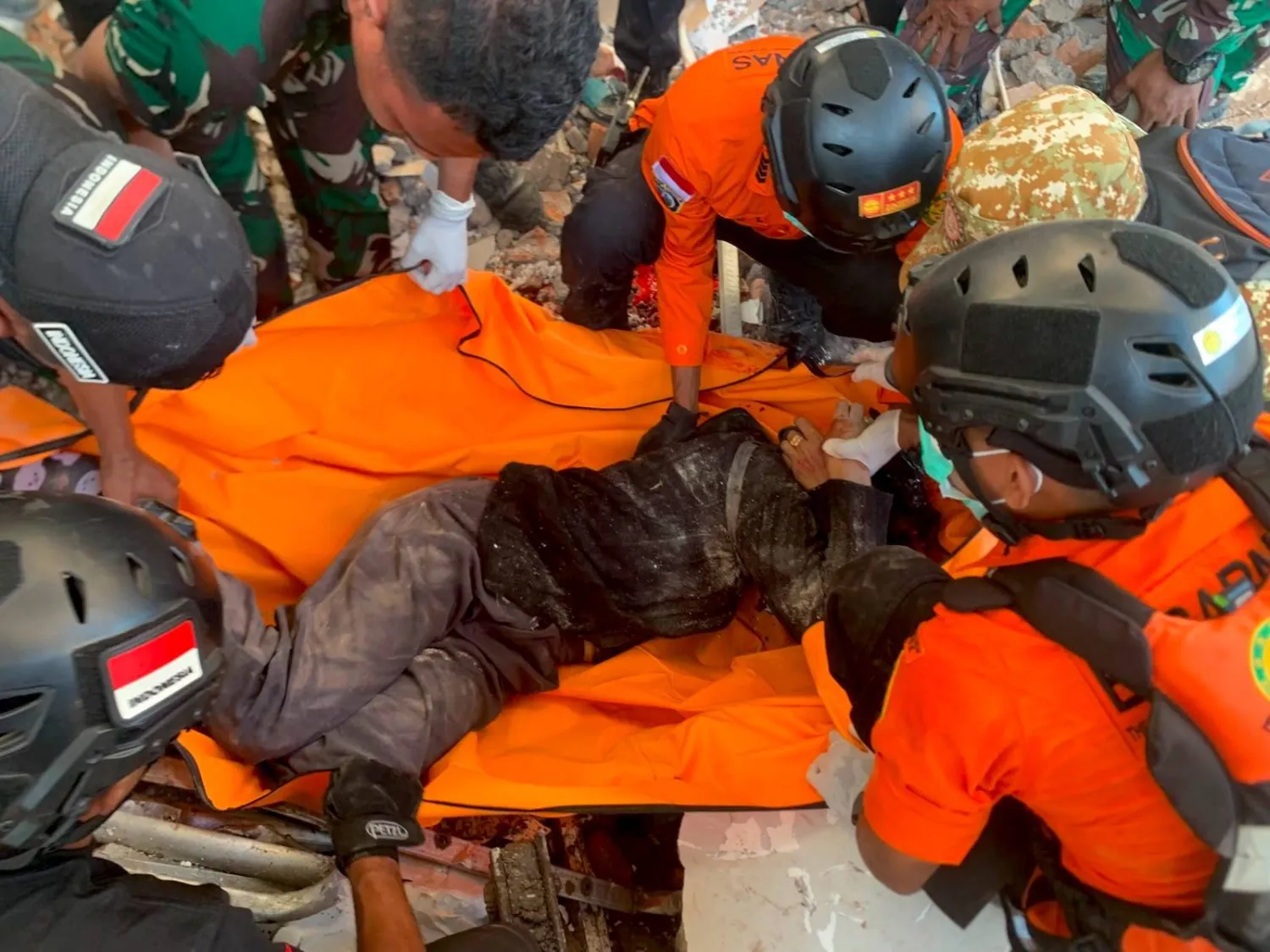 A handout photo made available by the National Search and Rescue Agency of Indonesia (BASARNAS) shows rescuers evacuating a victim after a 7.7 magnitude earthquake in Maumere, East Nusa Tenggara province, Indonesia, 15 August 2026.  EPA/BASARNAS