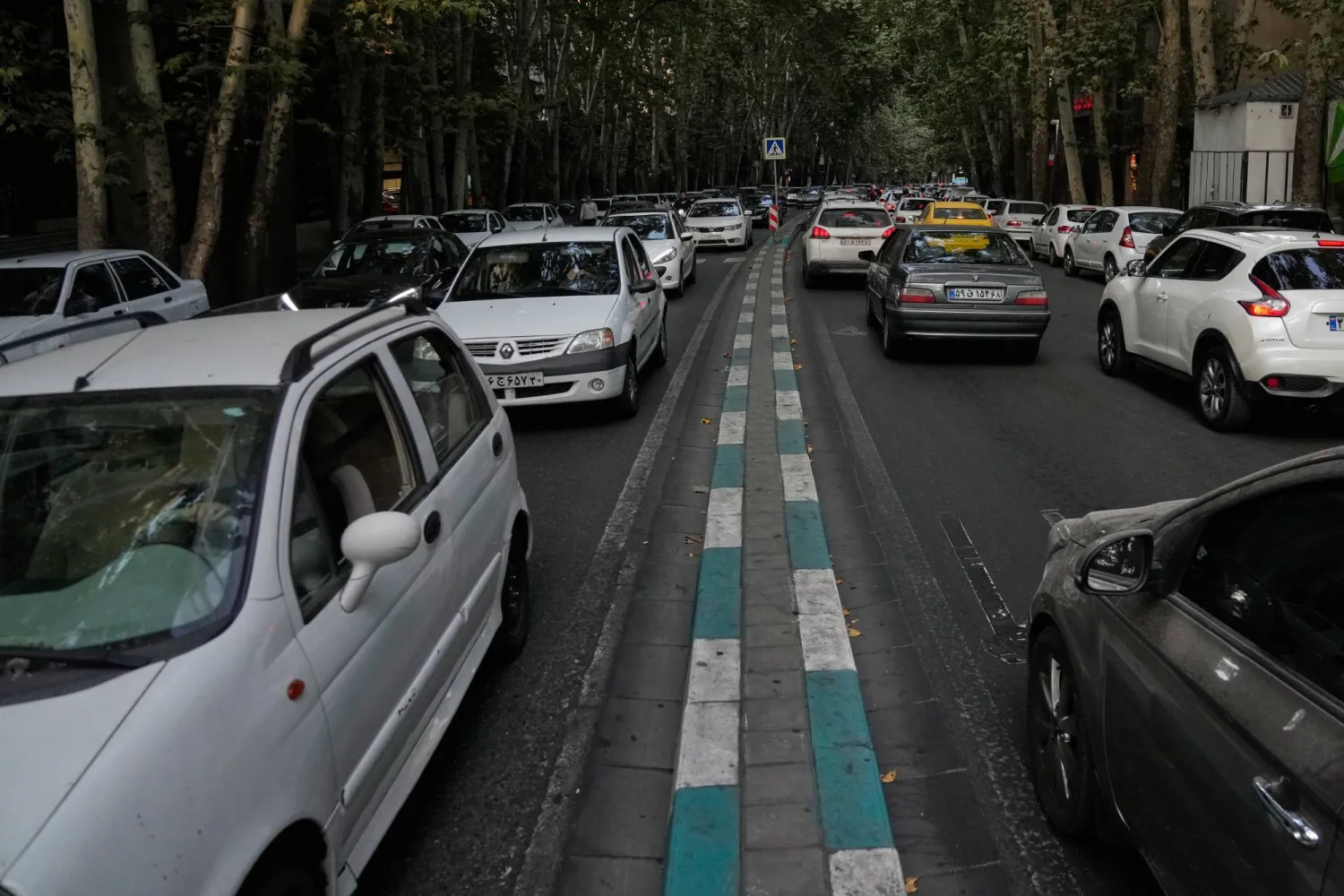 Vehicles drive along a street in northern Tehran, Iran, Thursday, Aug. 13, 2026. (AP Photo/Vahid Salemi)