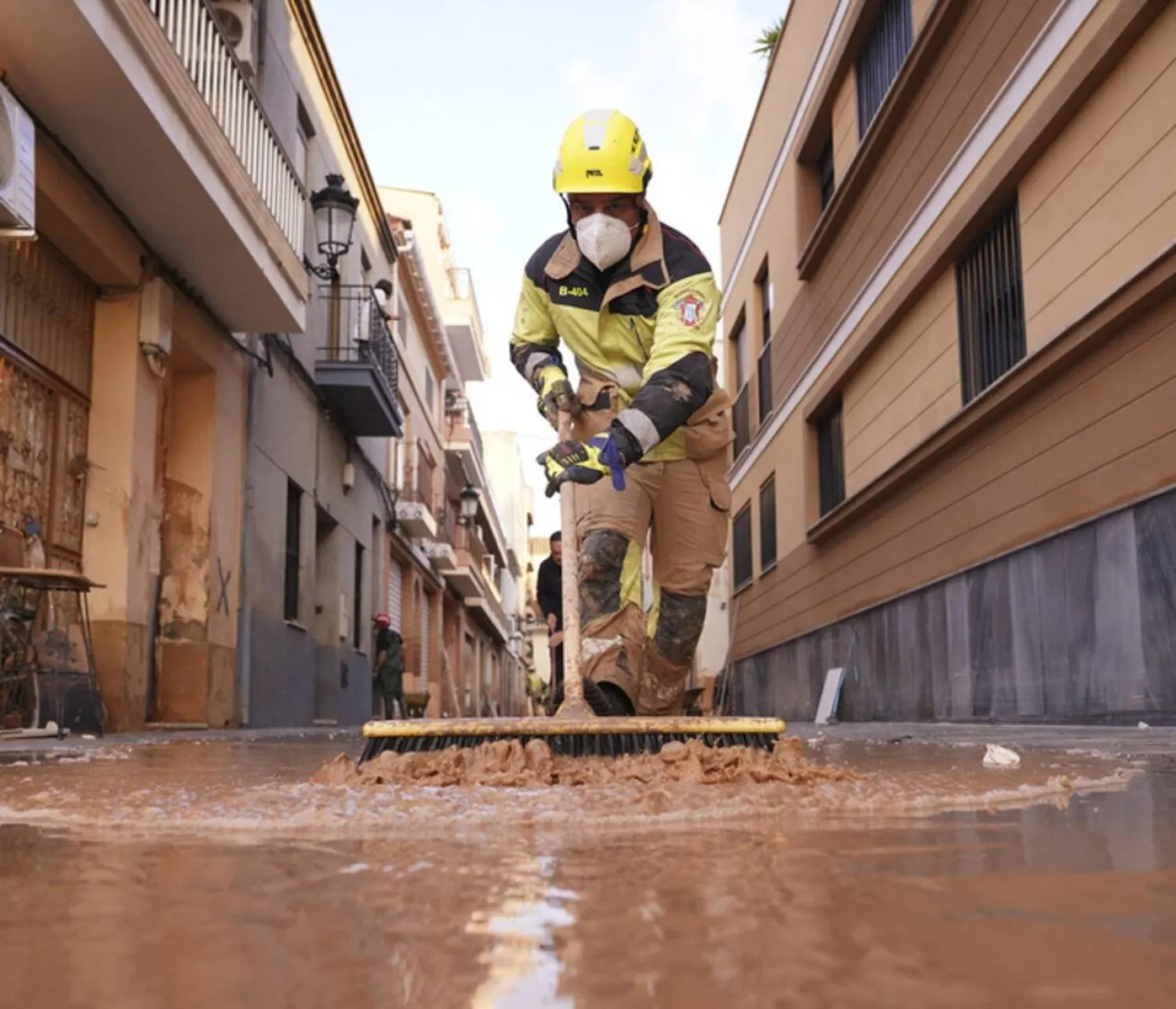  A firefighter sweeps away mud after floods in Paiporta, Spain on November 7, 2024. (AFP)