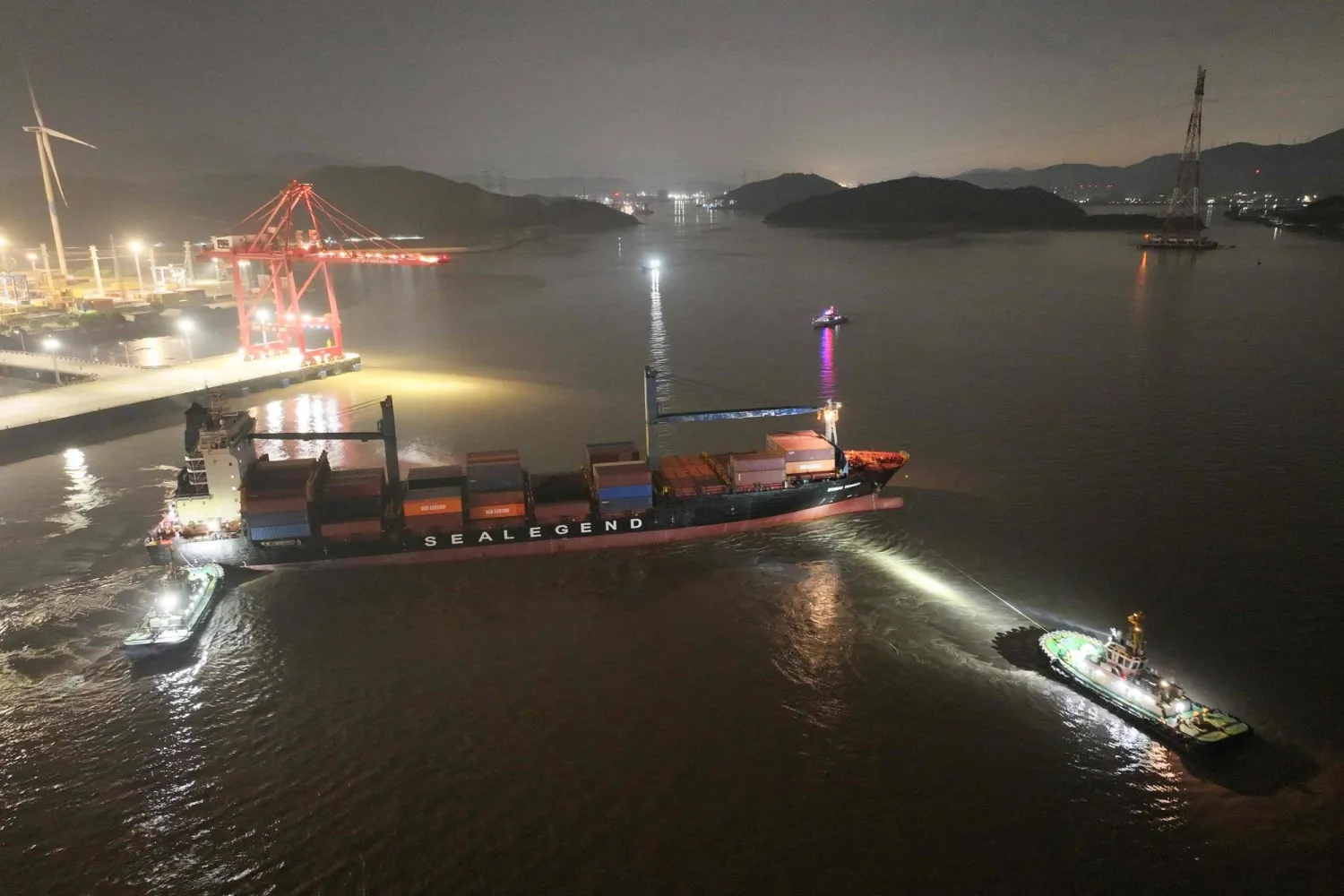 This handout photo taken and released on August 15, 2026 by the Ningbo Zhoushan Port Group shows the Dubai Tower container ship, operated by Chinese shipowner Sea Legend, setting sail from the port of Ningbo headed to the port of Felixstow, England. (Handout / Ningbo Zhoushan Port Group / AFP) 