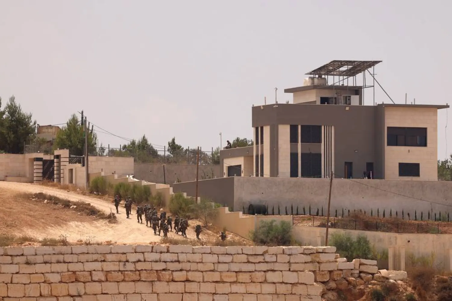 Israeli troops arrive during a military raid in the town of Qusra, south of Nablus, West Bank, 16 August 2026. (EPA)