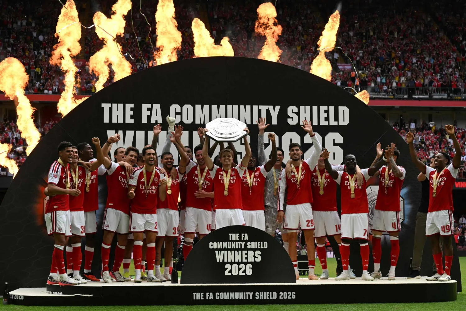 Arsenal's Norwegian midfielder #08 Martin Odegaard lifts the trophy as Arsenal's players celebrate their victory after the English FA Community Shield football match between Arsenal and Manchester City at The Principality Stadium, in Cardiff, south Wales on August 16, 2026. (AFP)