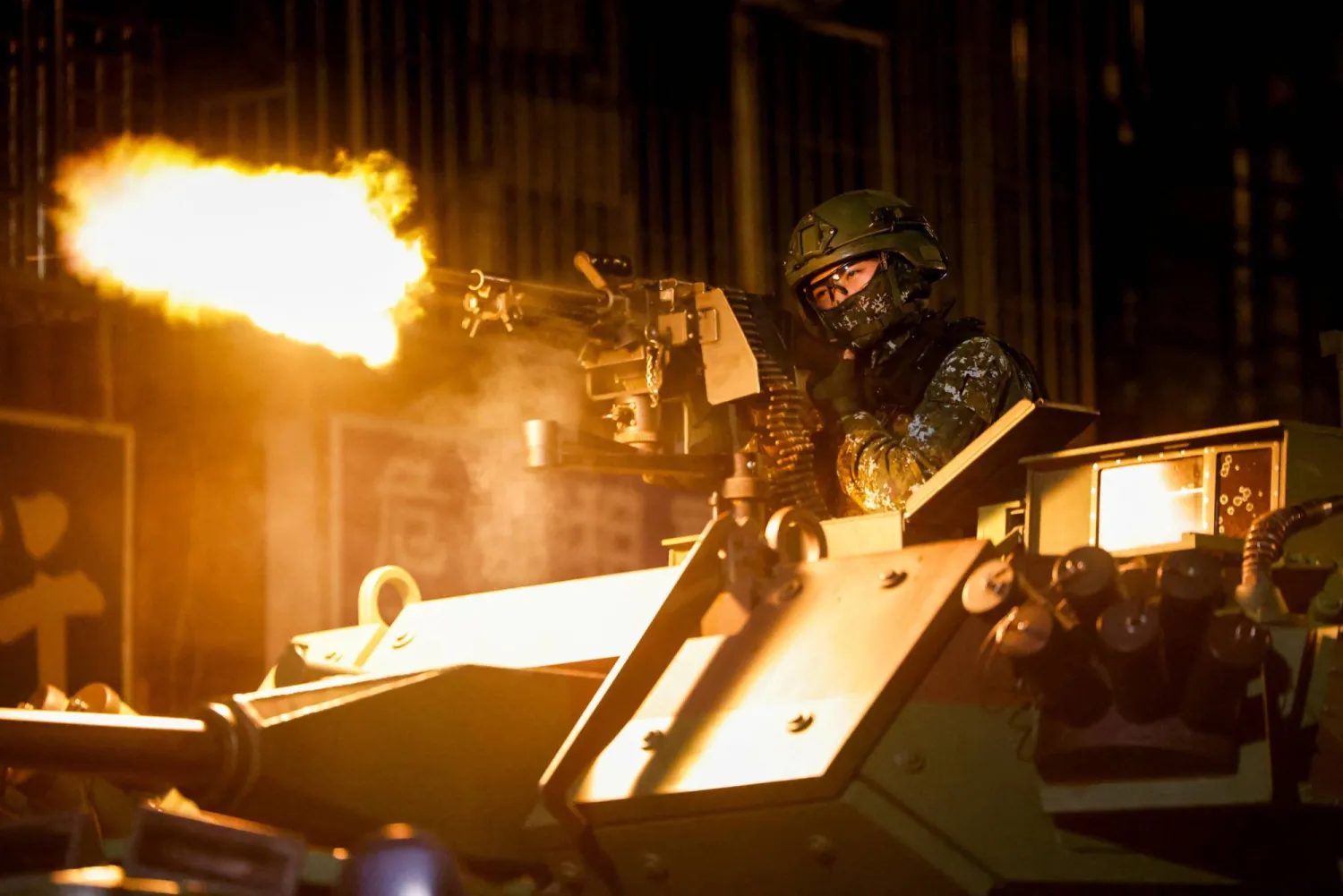 A Taiwanese military member fires ammunition aboard an armoured vehicle during a drill as part of the annual Han Kuang military exercises in Taipei, Taiwan, August 13, 2026. REUTERS/Ann Wang