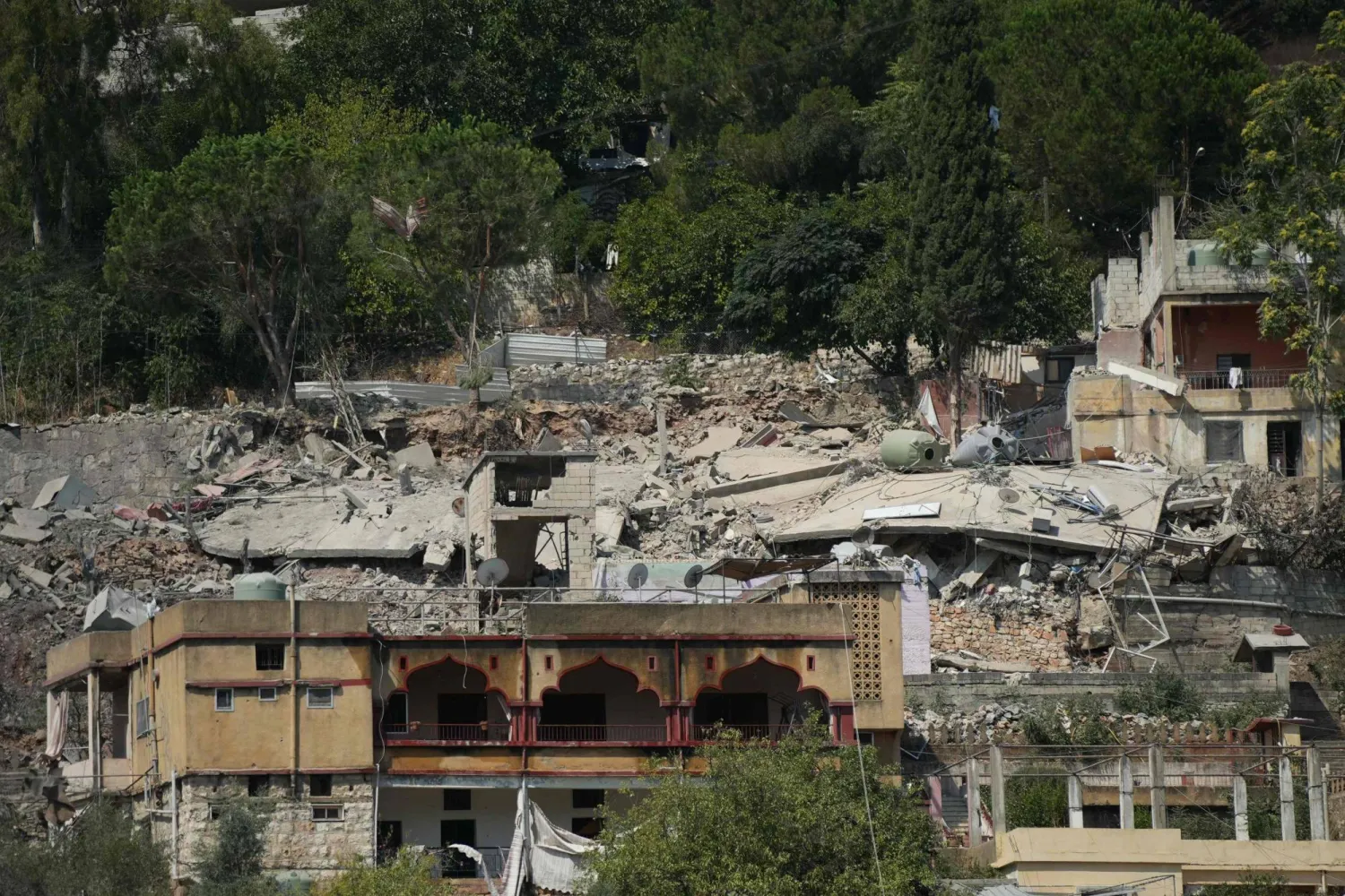 The rubble and debris of flattened buildings litter the hillside following an Israeli airstrike that targeted a neighborhood in the southern Lebanese village of Nabatieh al-Fawqa on August 15, 2026. (AFP)