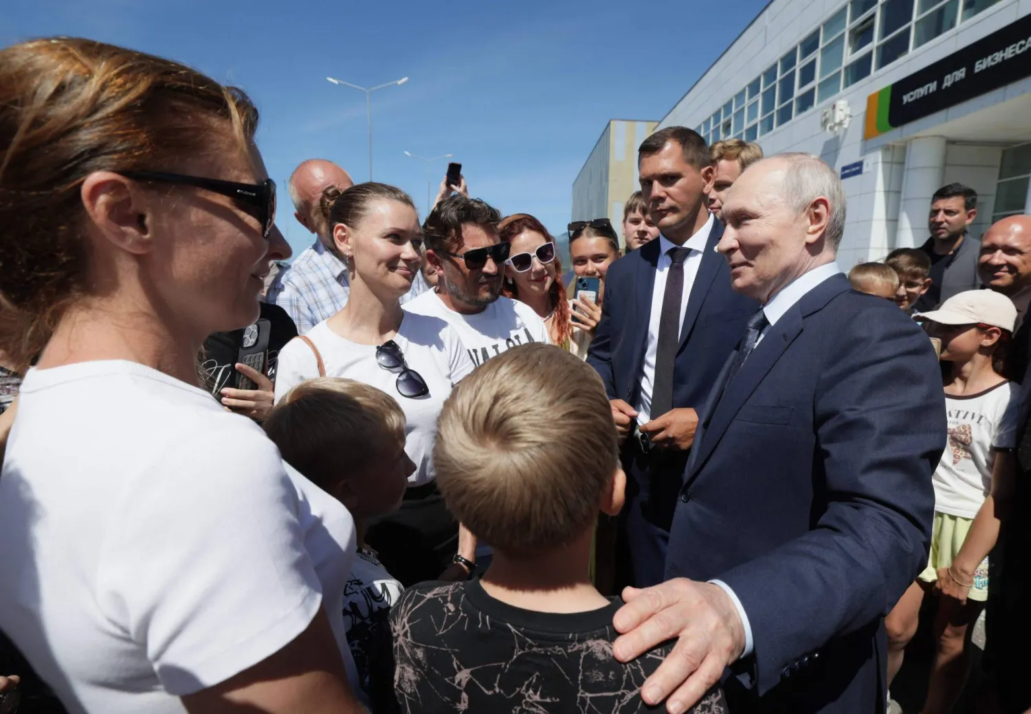  In this pool photograph distributed by the Russian state agency Sputnik, Russia's President Vladimir Putin interacts with local residents on Iturup island, one of four islands in the contested chain known as the Kuril Islands in Russia and the Northern Territories in Japan, on August 13, 2026. (Gavriil Grigorov / Pool / AFP) 