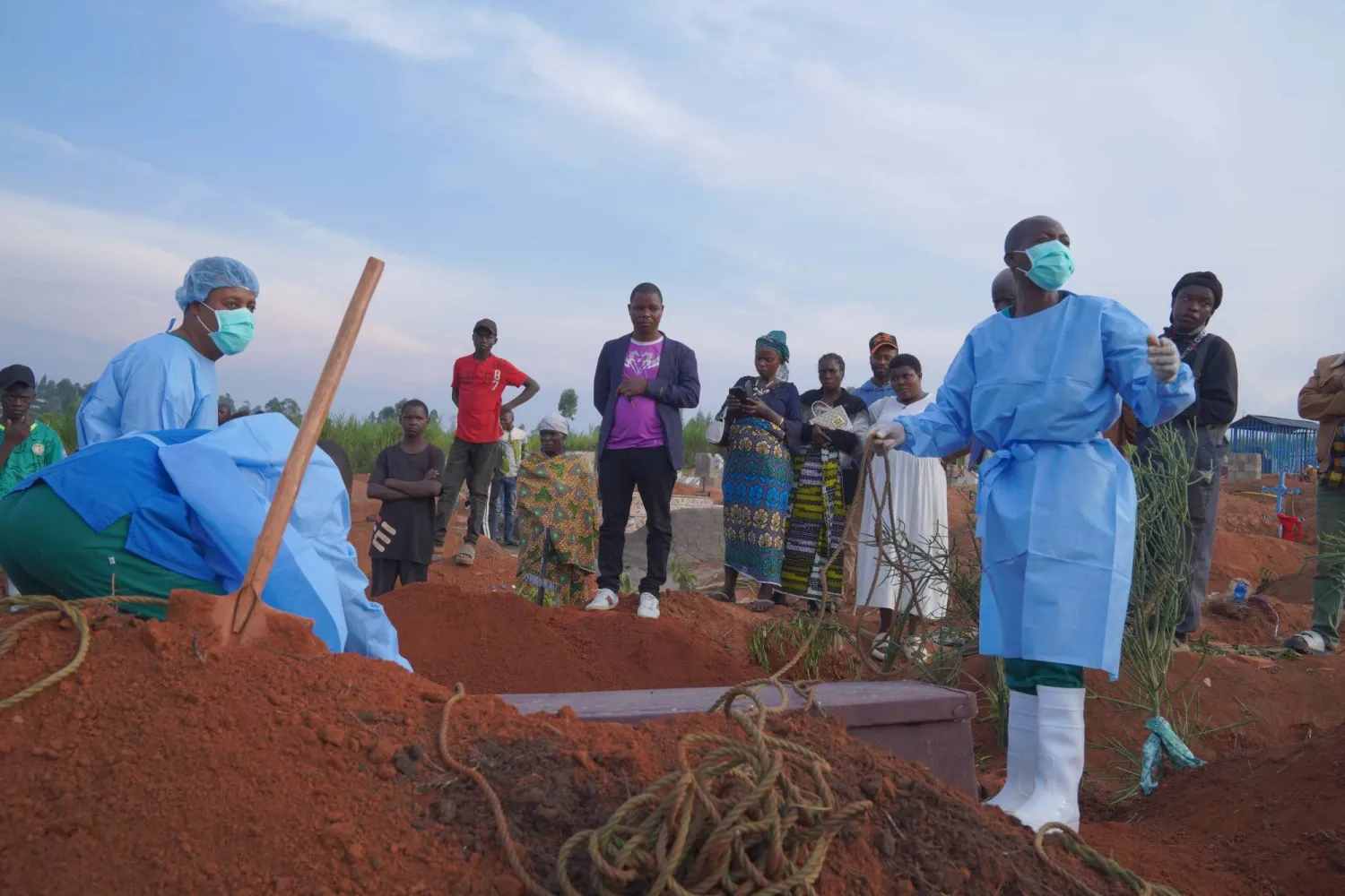 People wearing protective clothing prepare for the burial of a man at Nyamurongo Cemetery in Bunia, Democratic Republic of the Congo, 18 August 2026. EPA/DIEUDONNE DIROLE
