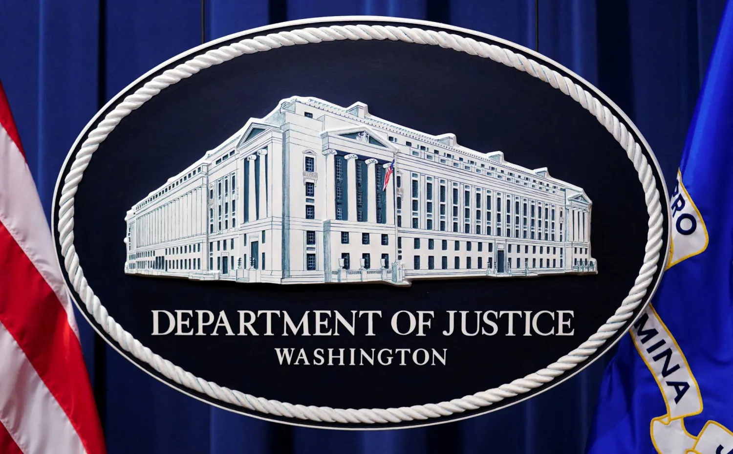 A U.S. Justice Department logo or seal showing Justice Department headquarters, known as "Main Justice," is seen behind the podium in the Department's headquarters briefing room before a news conference with the Attorney General in Washington, January 24, 2023. (Reuters)
