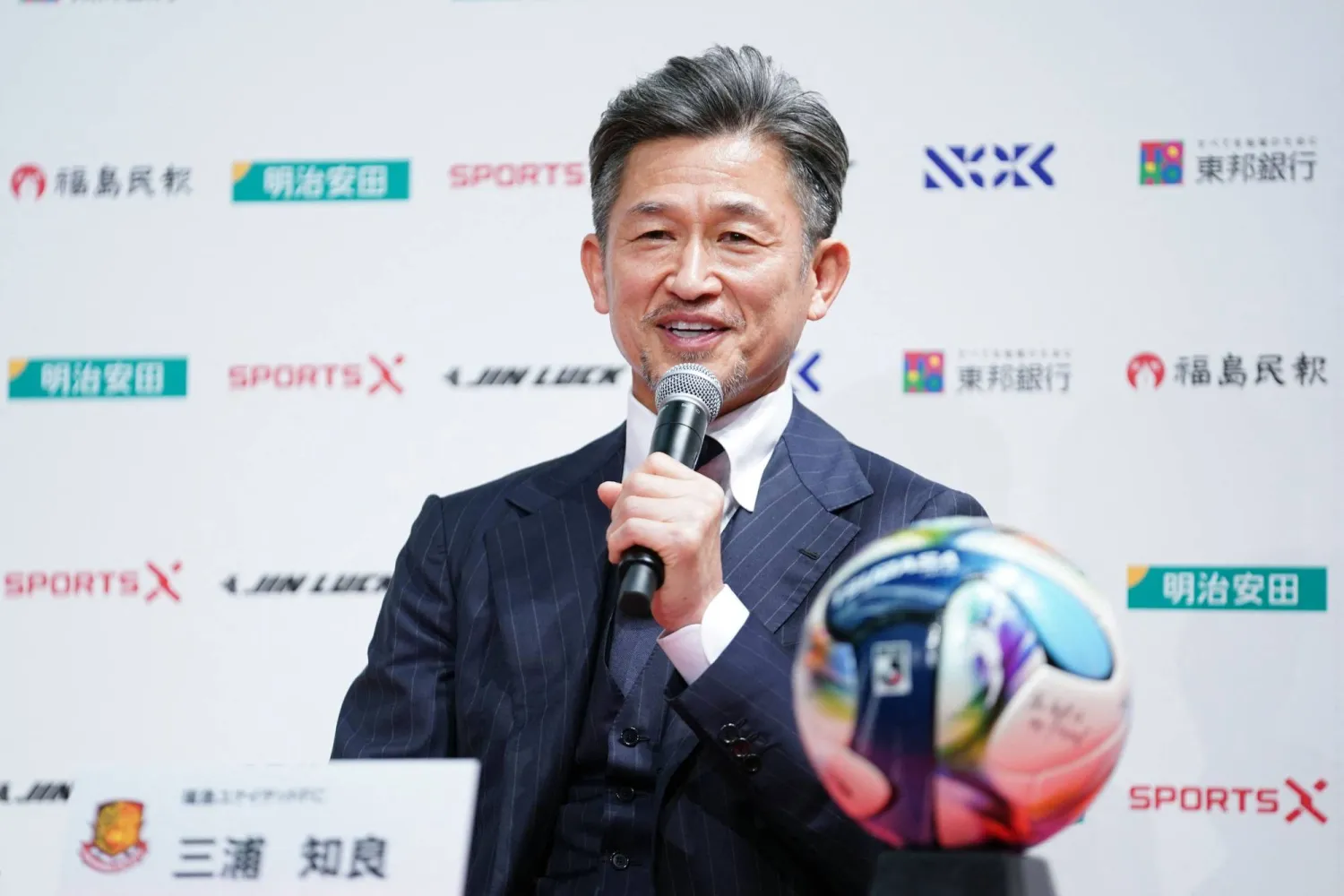 (FILES) Japanese footballer Kazuyoshi Miura speaks during a press conference to announce his joining of Fukushima United FC in the J-League third division, in Tokyo on January 9, 2026. (Photo by Kazuhiro NOGI / AFP)