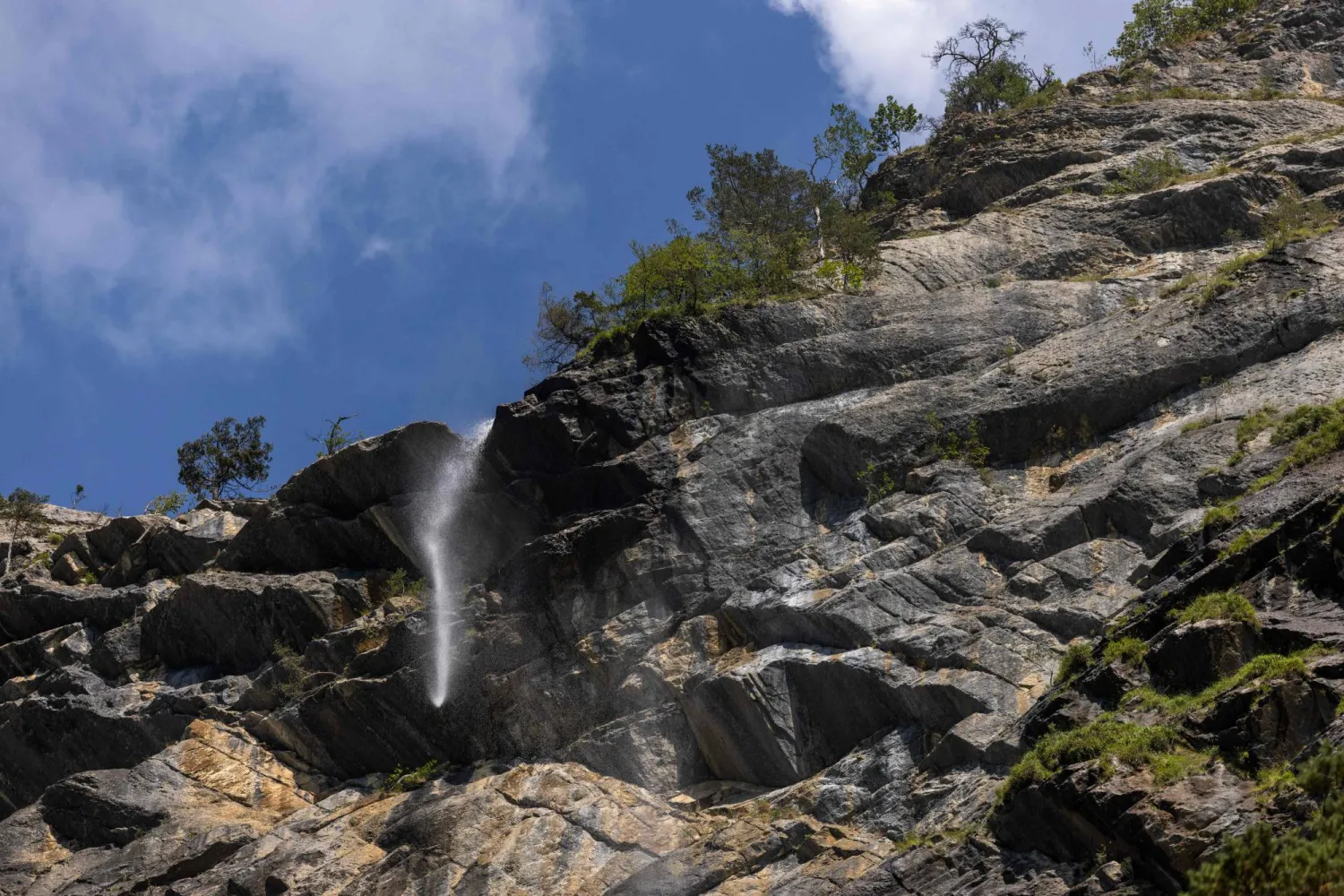 This photo shows the very low flow of the Arpenaz Waterfall, in Sallanches, central-eastern France, on August 12, 2026. (Photo by Alex MARTIN / AFP)