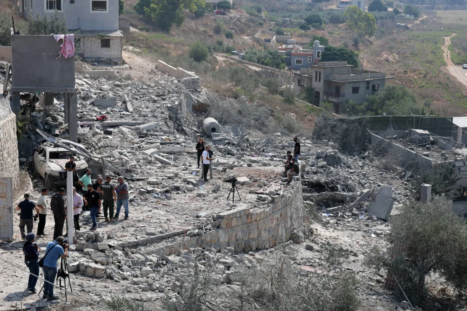 People inspect a damaged building after an Israeli airstrike on the village of Ansar, southern Lebanon, 15 August 2026. (EPA)