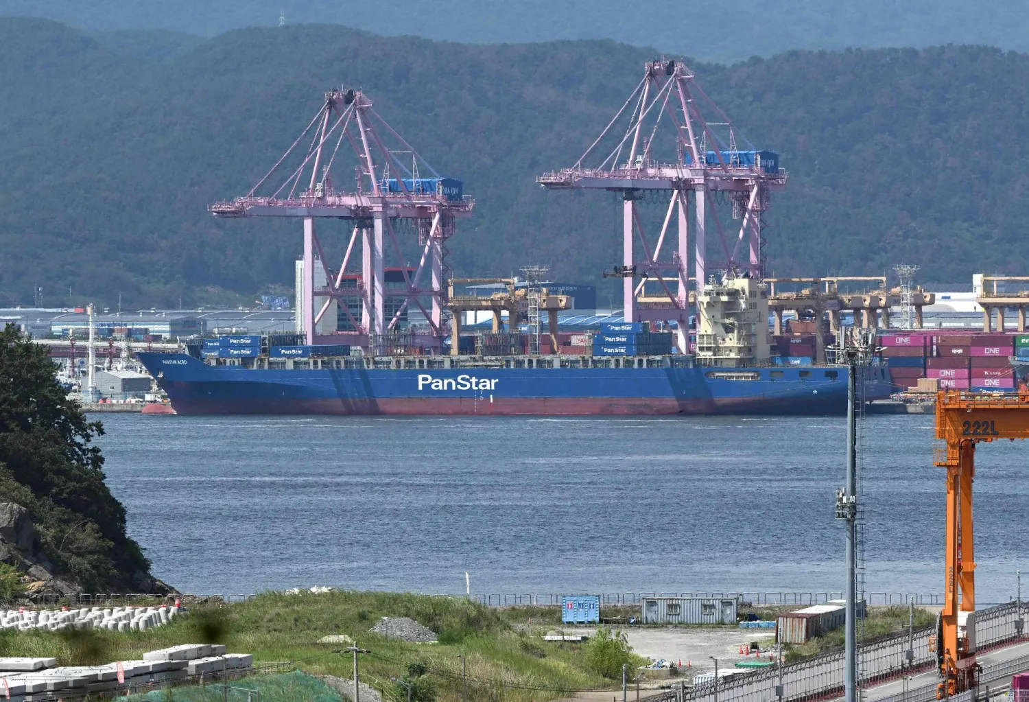 The container ship "Panstar Acro" is anchored to load containers at Busan New Port in Busan on August 22, 2026, as the vessel is scheduled to sail to Europe via the Arctic to test the commercial viability of the shipping route opened by melting ice. (AFP) 