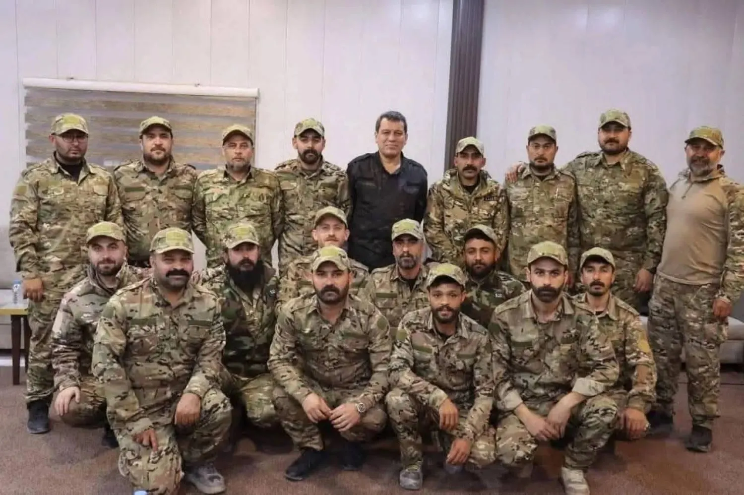 SDF Commander Mazloum Abdi with his fighters wearing the military uniform of the Syrian army in February. (Social media)