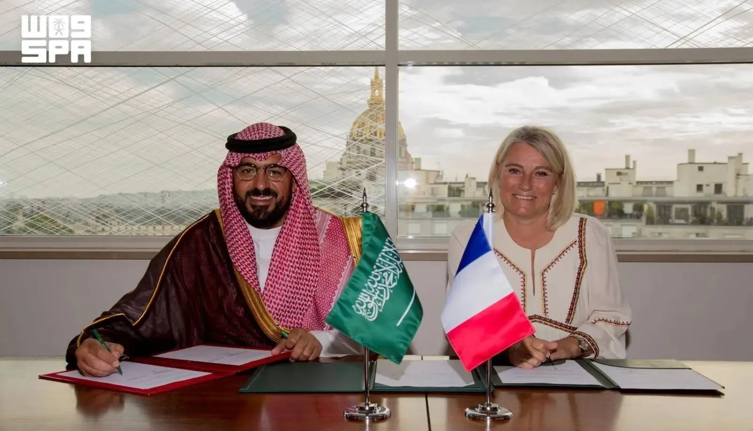 Saudi Minister of Economy and Planning Faisal Alibrahim and French Minister of Health, Families, Autonomy and Persons with Disabilities Stephanie Rist sign the agreement on Monday. (SPA)