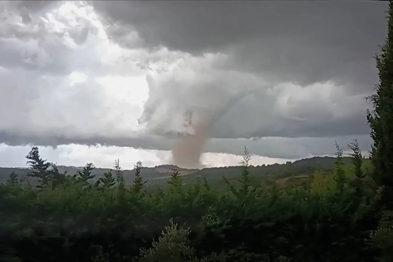 This video grab taken from Villefloure, shows a tornado hitting Pomas, southwestern France, on August 24, 2026. (Photo by Cyrille Kaldor / UGC / AFP / AFP)